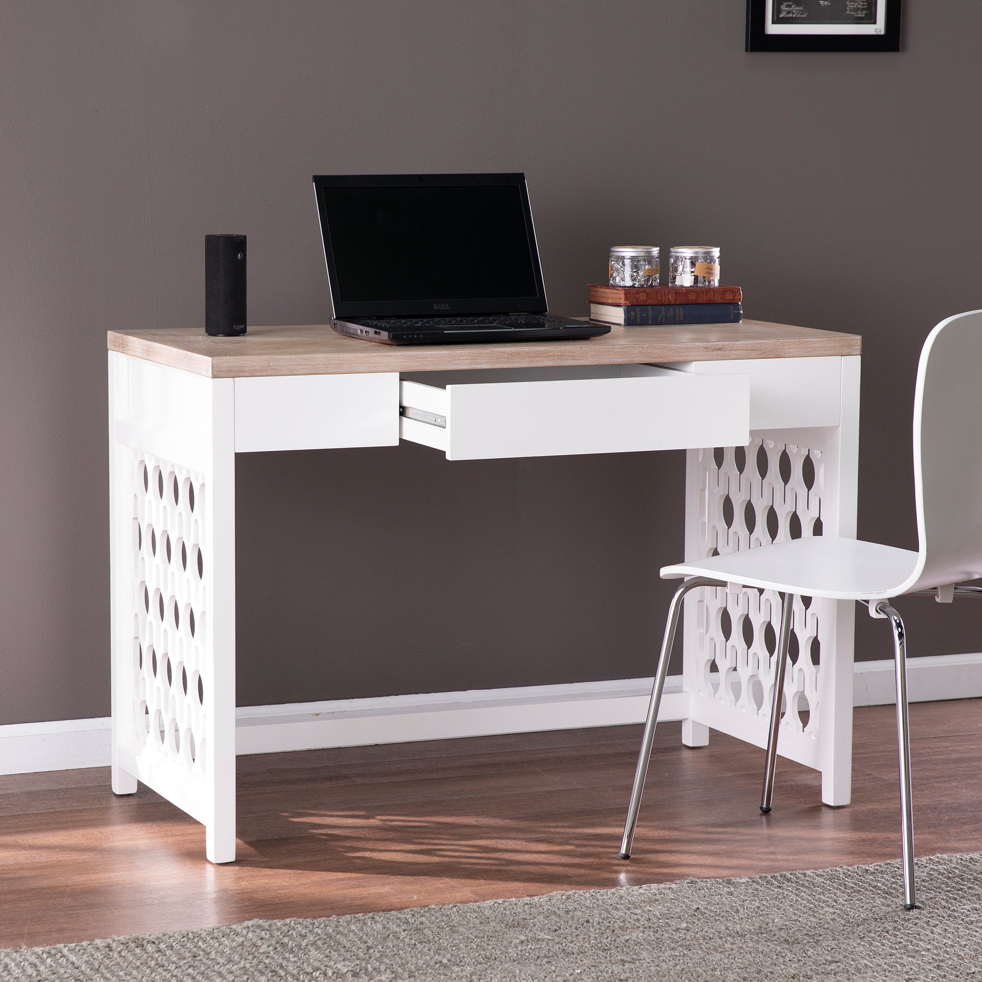 Modern white and wood writing desk with open drawer and decorative side panels