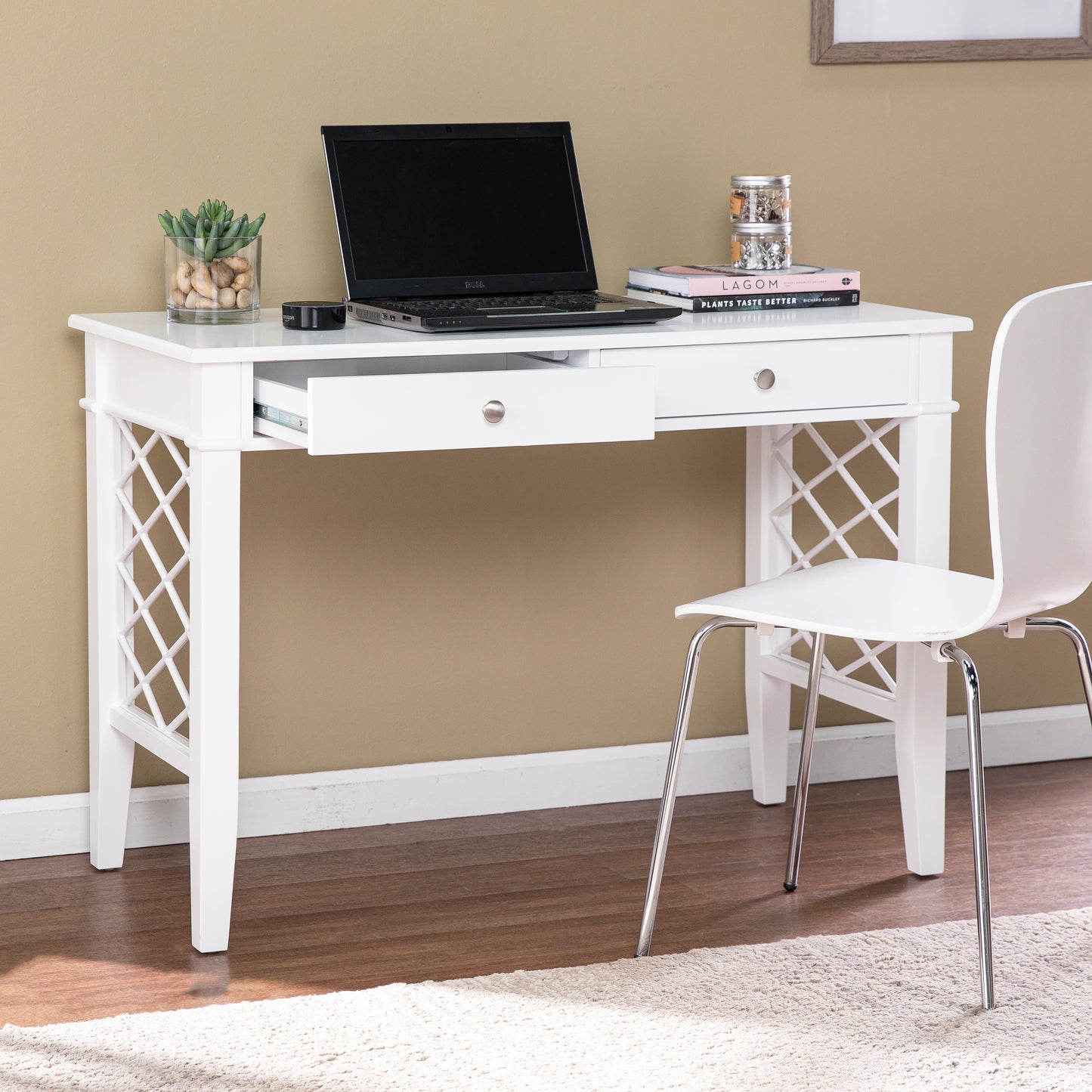 White wooden writing desk with decorative lattice sides and two drawers