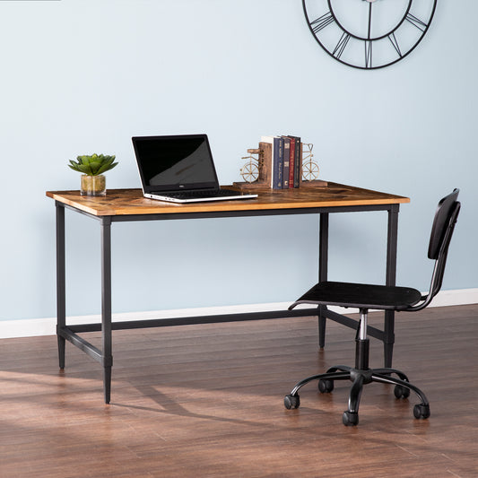 Rustic wood and metal desk with laptop plant and books