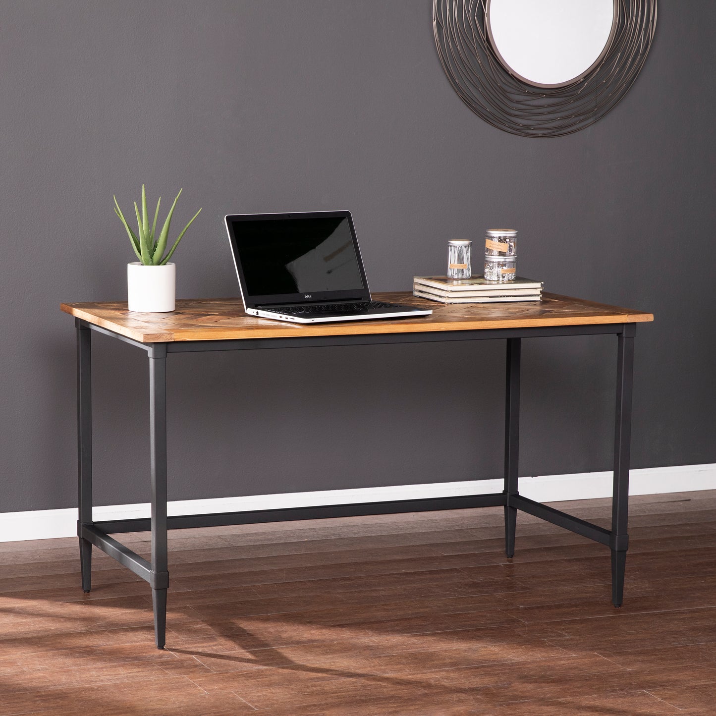 Rustic wood desk with black metal legs and a laptop for home office
