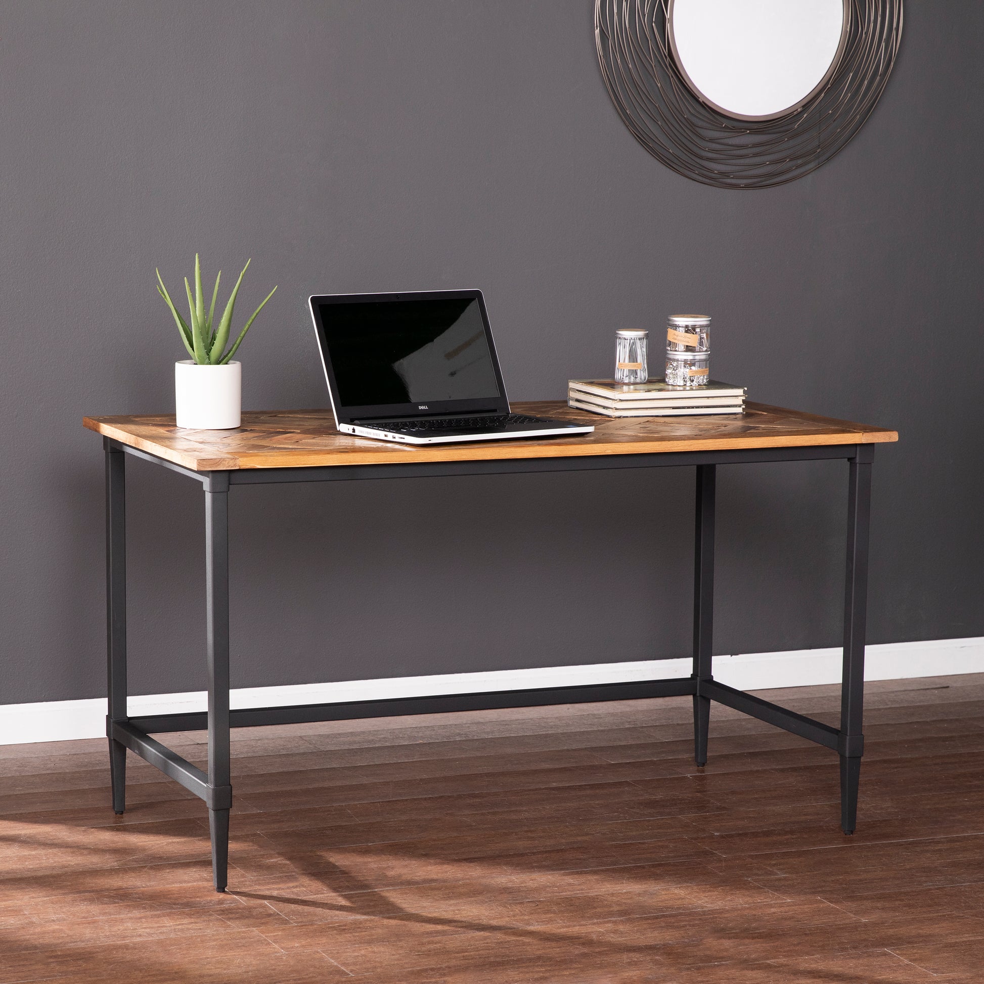 Rustic wood desk with black metal legs and a laptop for home office