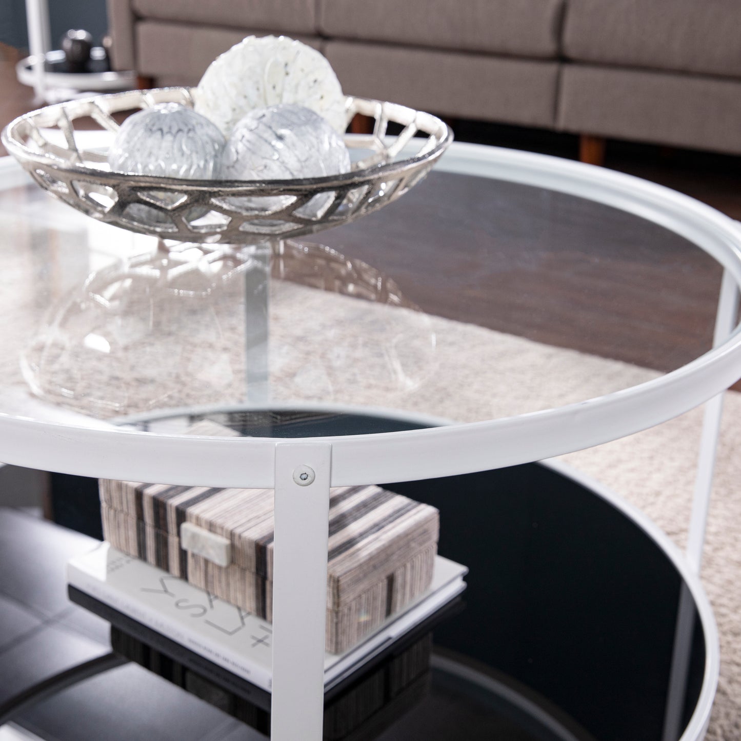 White metal frame coffee table with glass top and decorative orbs