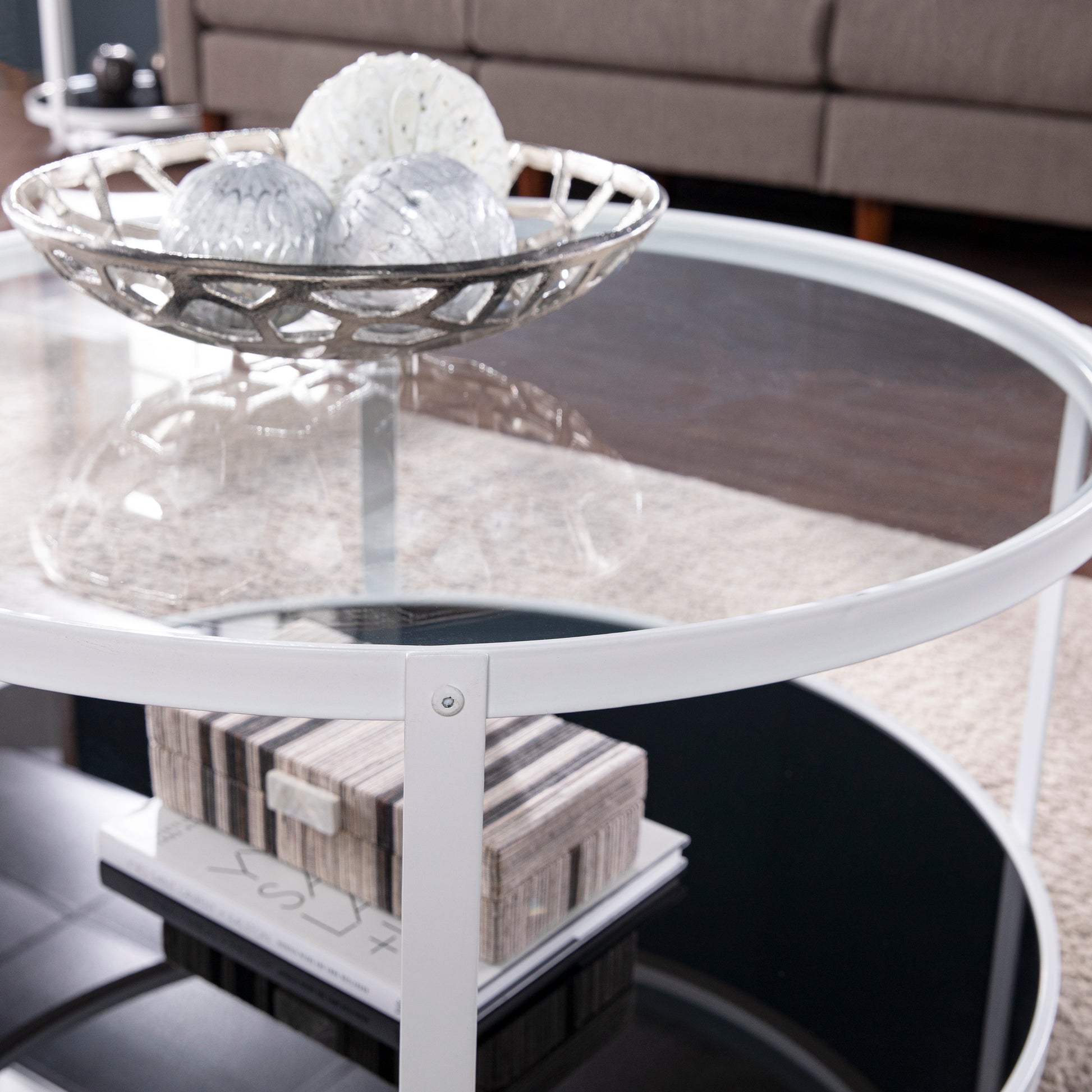 White metal frame coffee table with glass top and decorative orbs