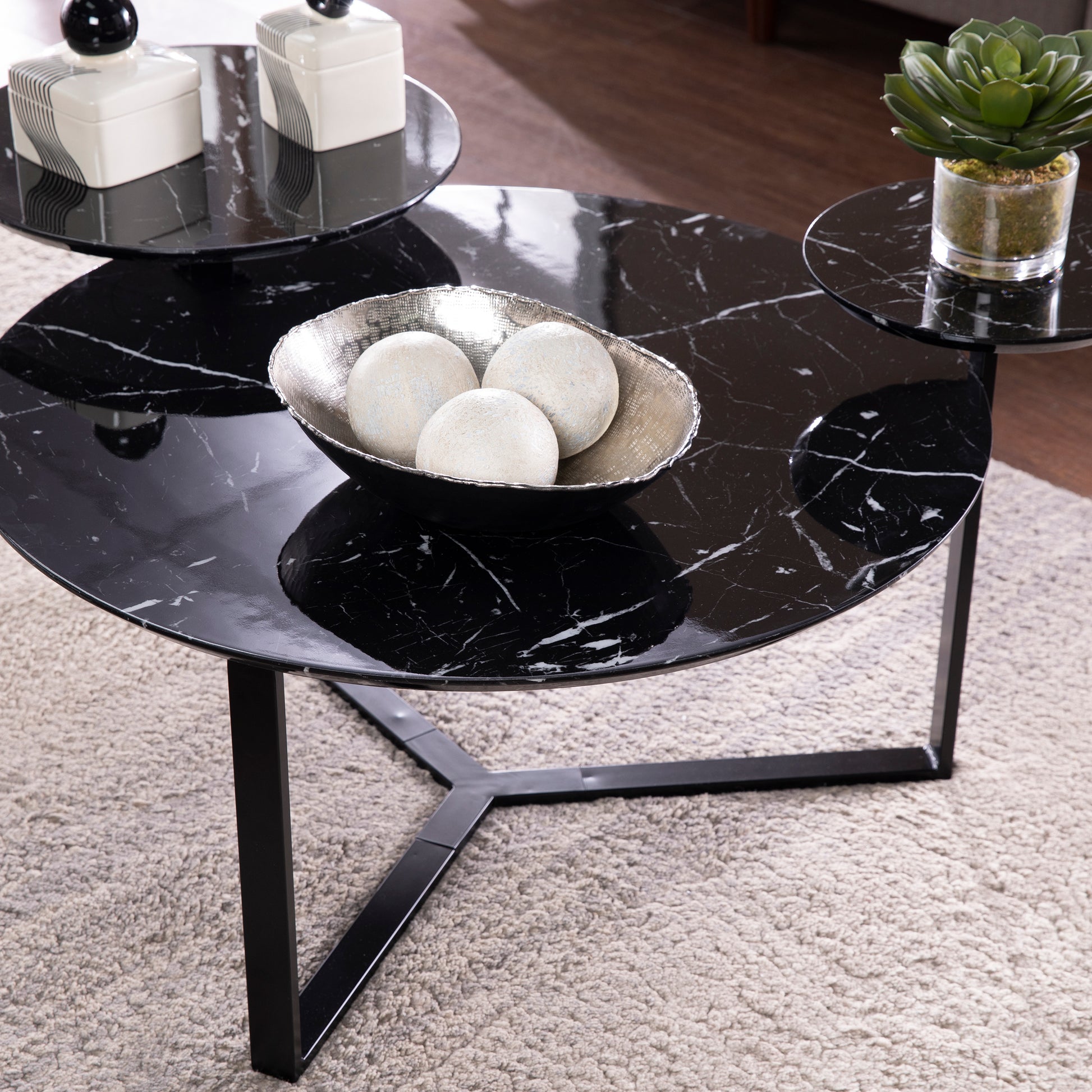 Chic black marble nesting coffee table with sleek metal base perfect for modern living spaces