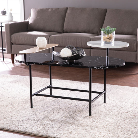 Modern oval coffee table with black marble top and tiered design
