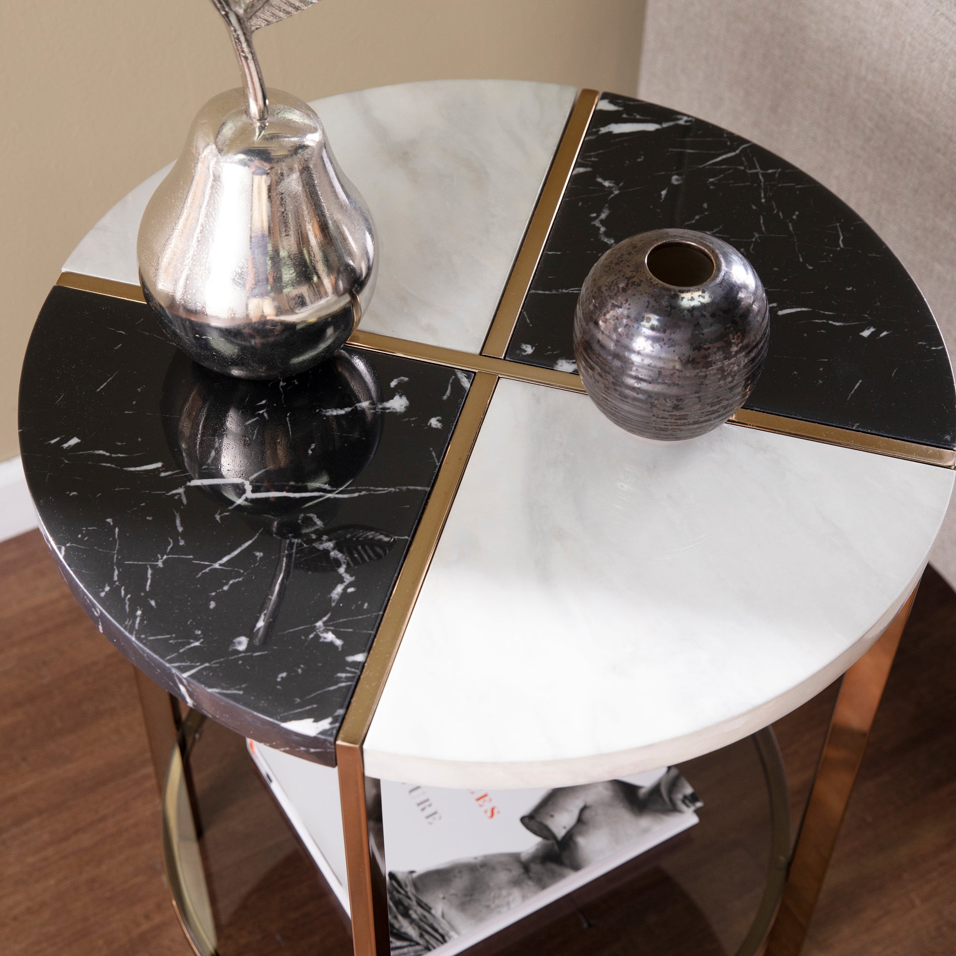 Round marble side table with black and white marble inlay and gold trim