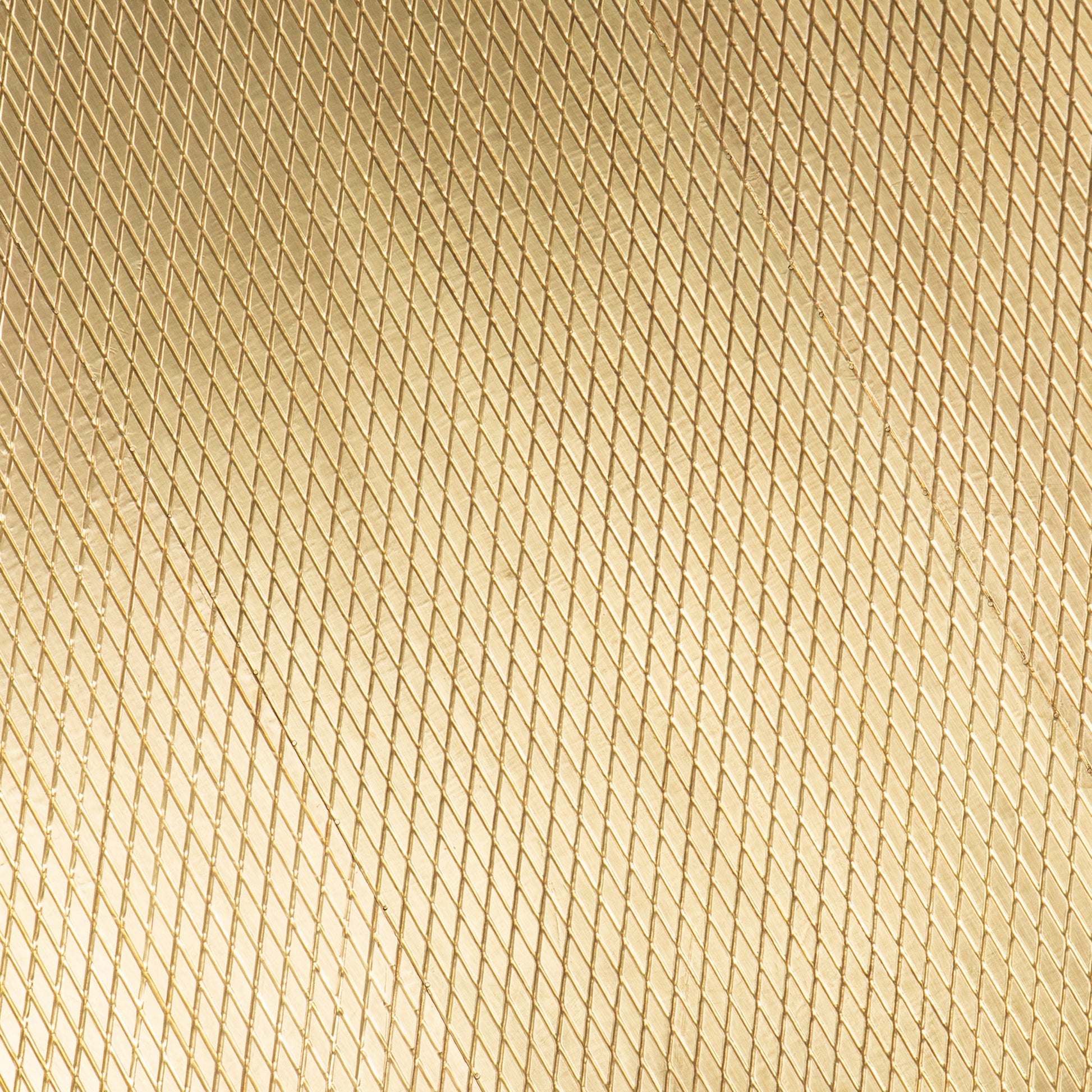 Closeup of a gold diamond plate metal sheet texture with a textured metallic finish