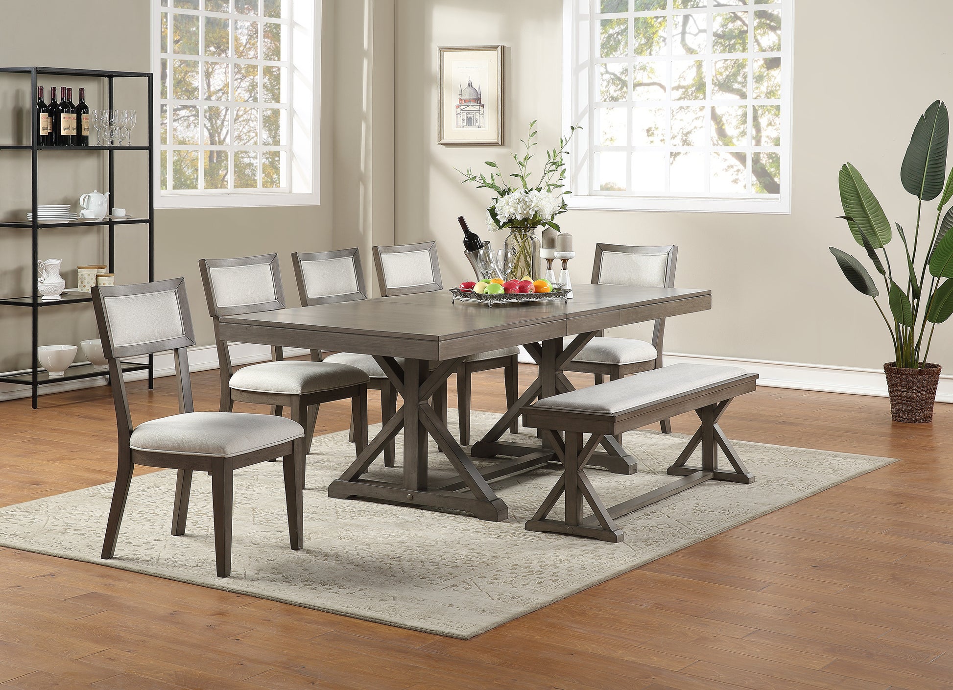 Gray dining table set with upholstered chairs and bench