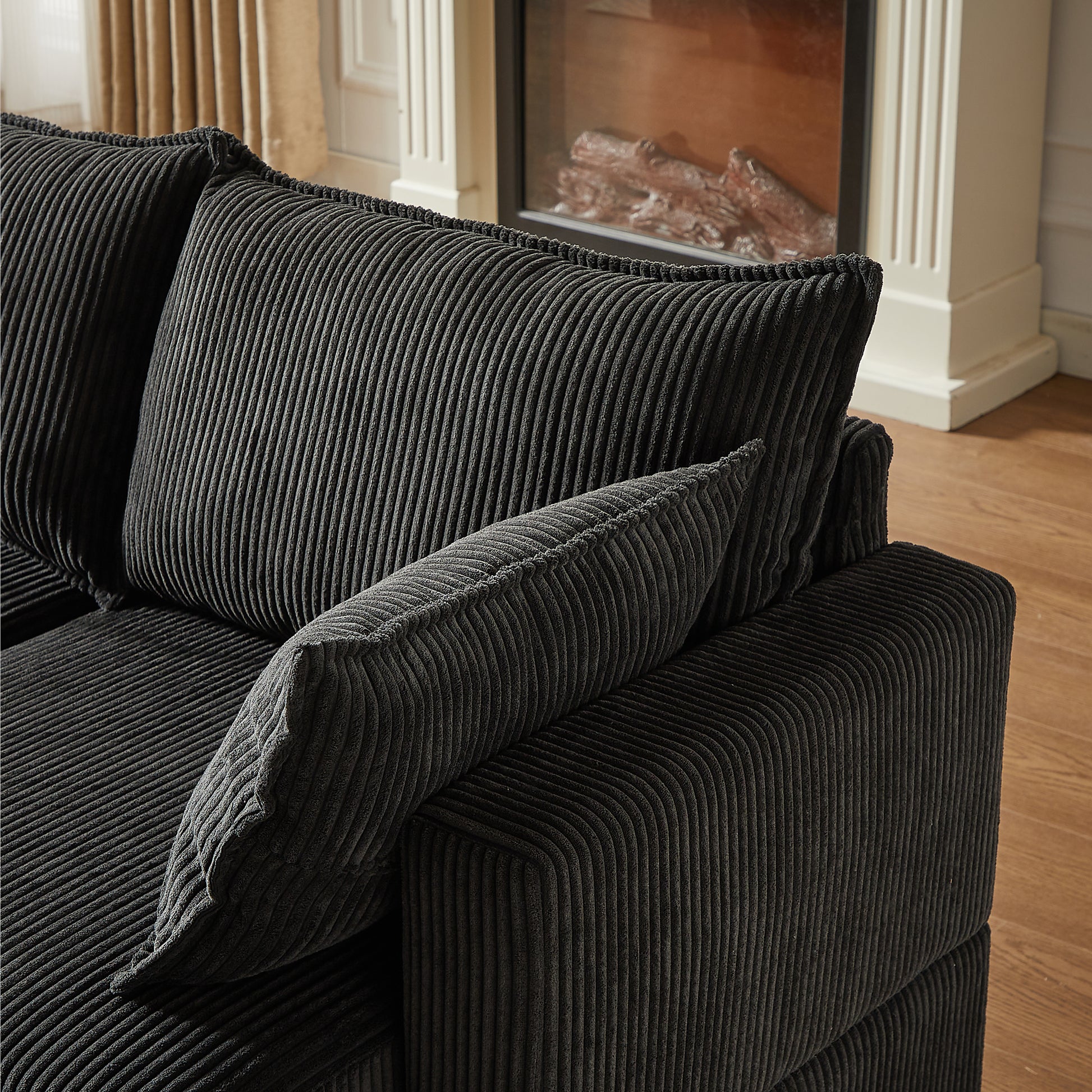Closeup of a charcoal corduroy sofa sectional with plush cushions showcasing texture