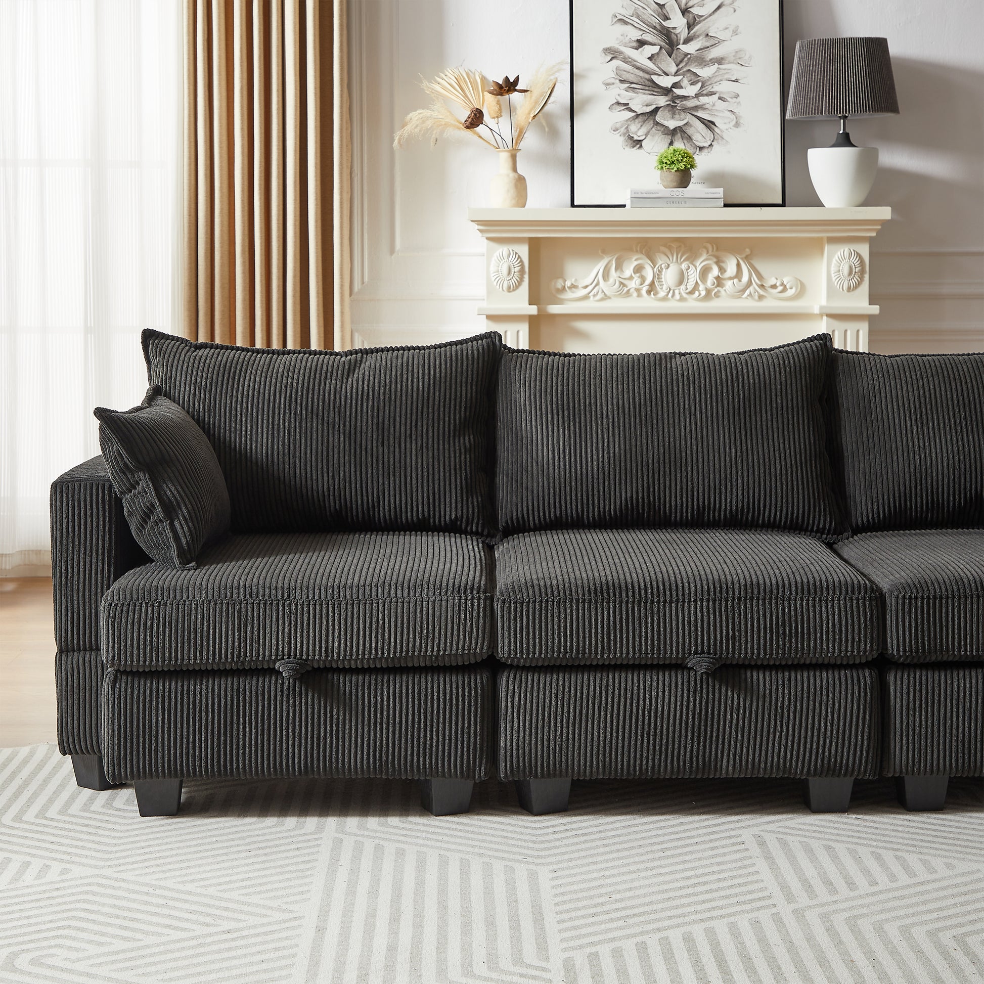 Dark gray corduroy sectional sofa with plush throw pillows for a modern living room
