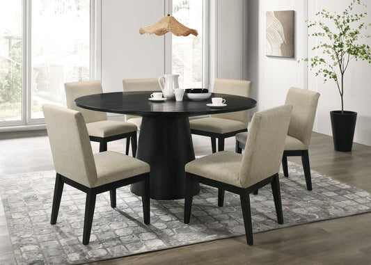 Round black dining table with pedestal base and four neutral upholstered chairs