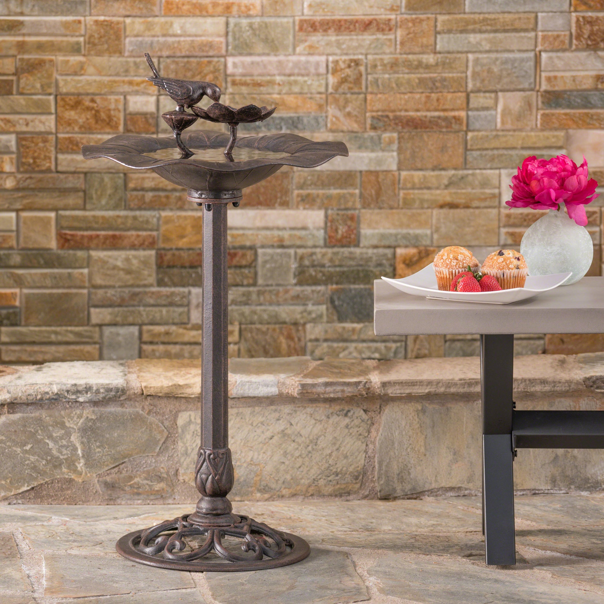 Ornate cast iron bird bath with two birds perched on top antique bronze finish