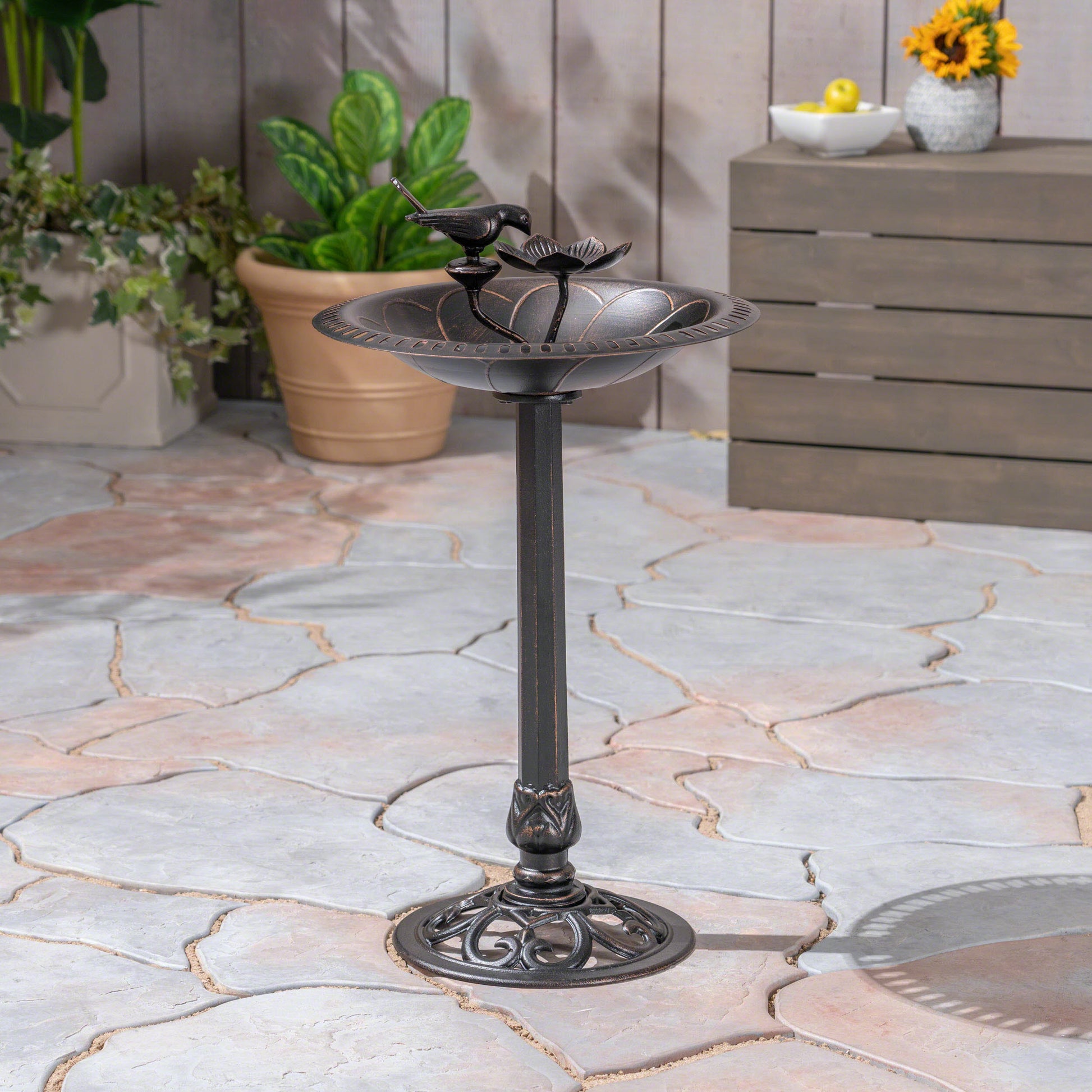Bronze bird bath with decorative floral rim and bird perch perfect for garden decor
