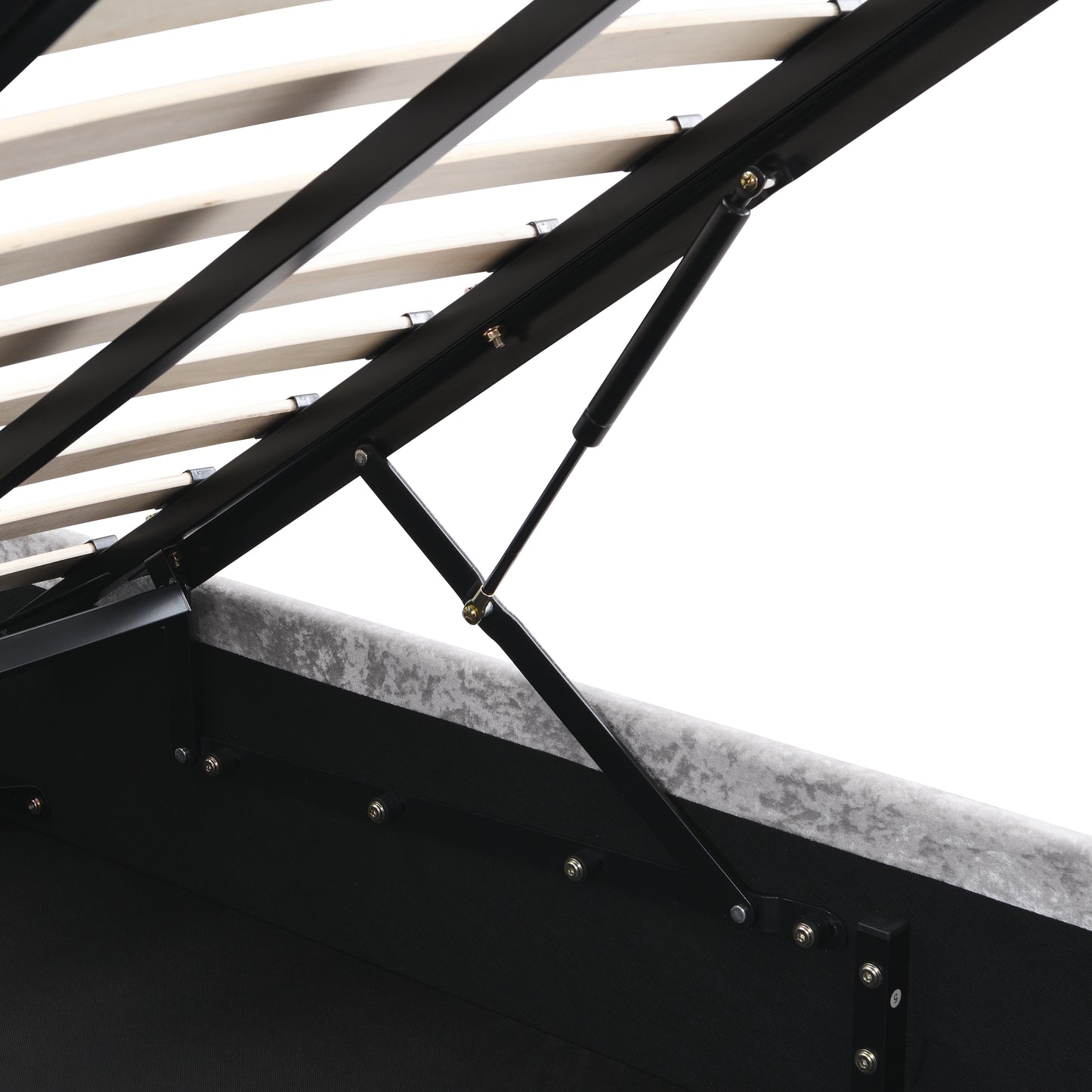 Close up of gas lift mechanism on a grey velvet storage bed frame with wooden slats