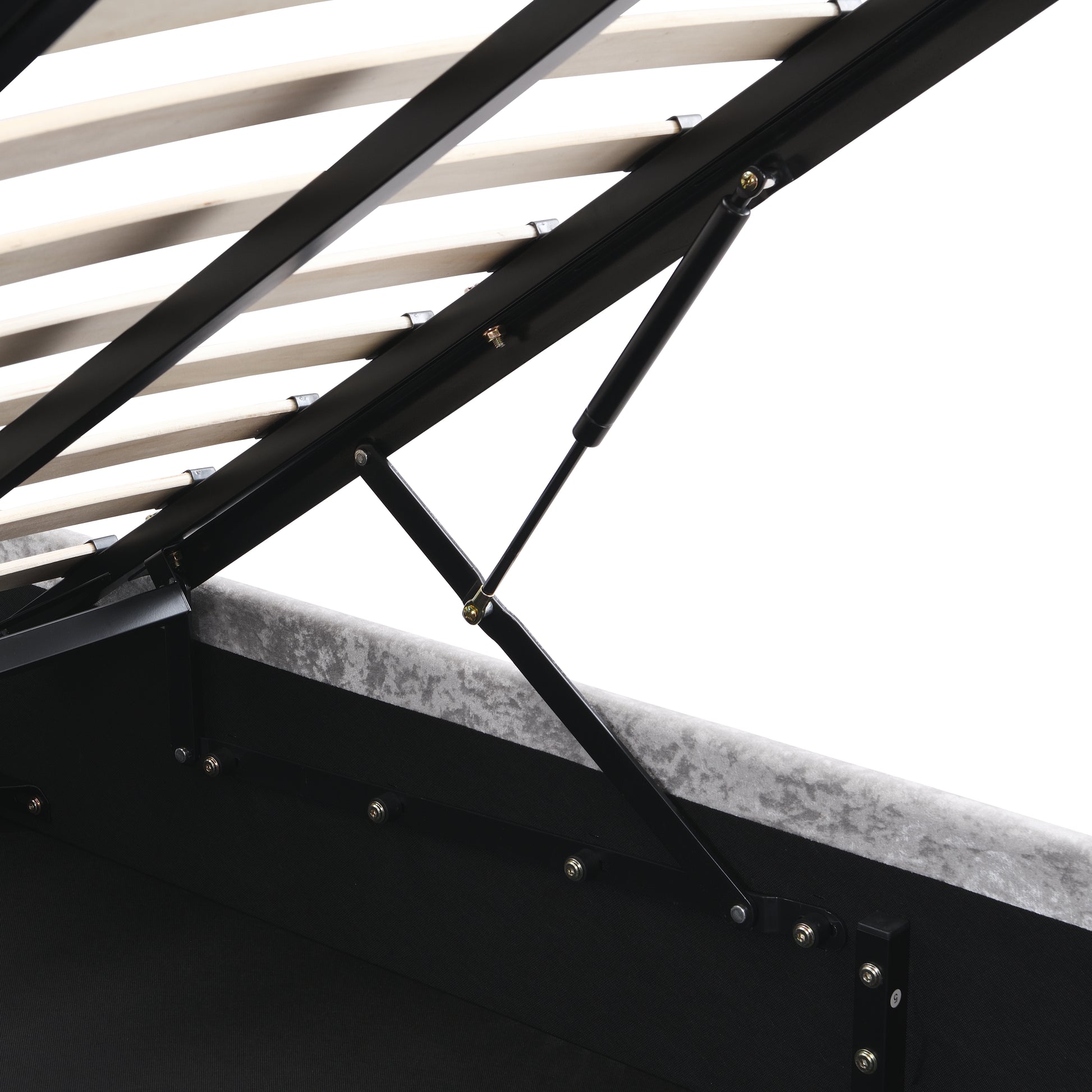 Close up of gas lift mechanism on a grey velvet storage bed frame with wooden slats