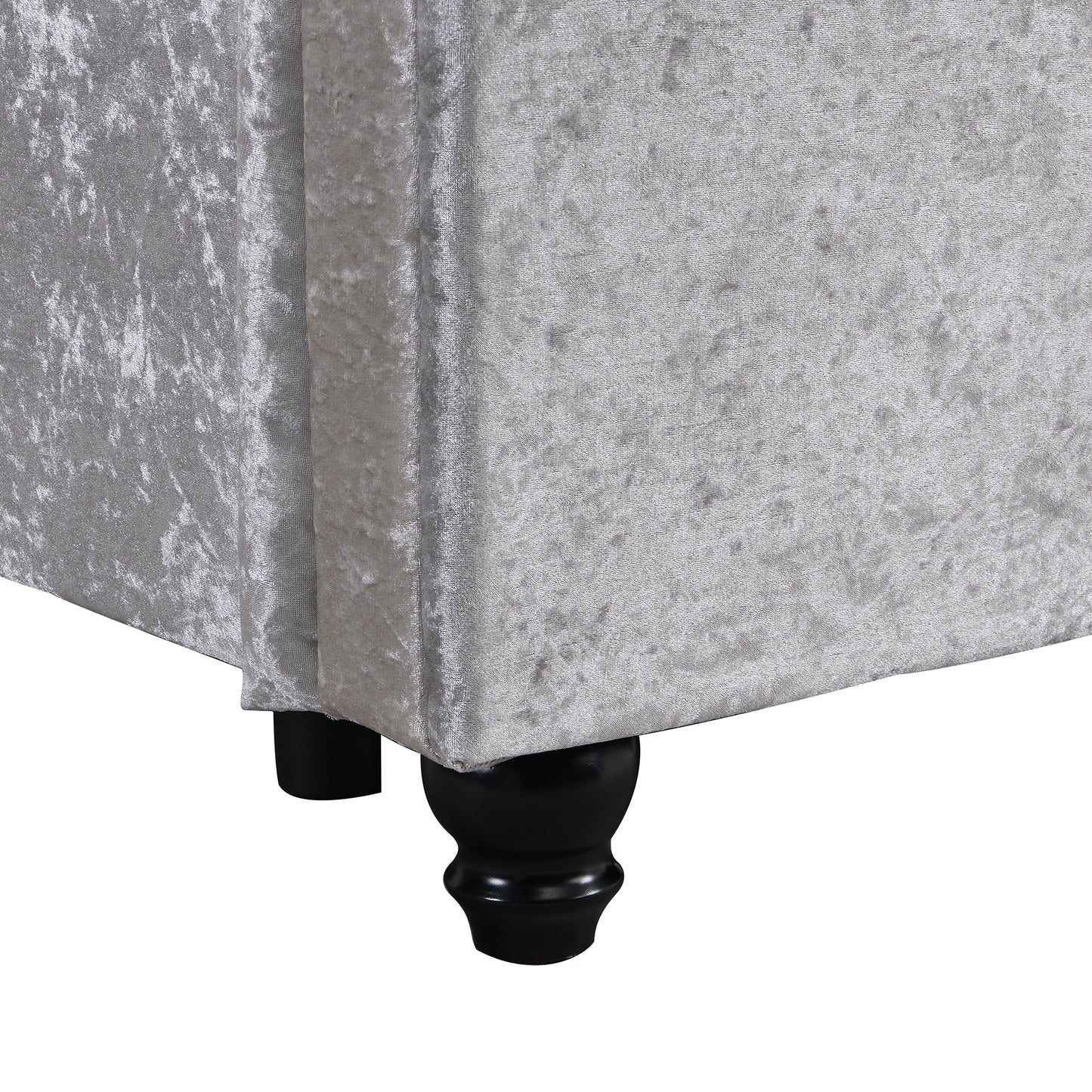 Closeup of crushed velvet upholstery in silver with black turned legs