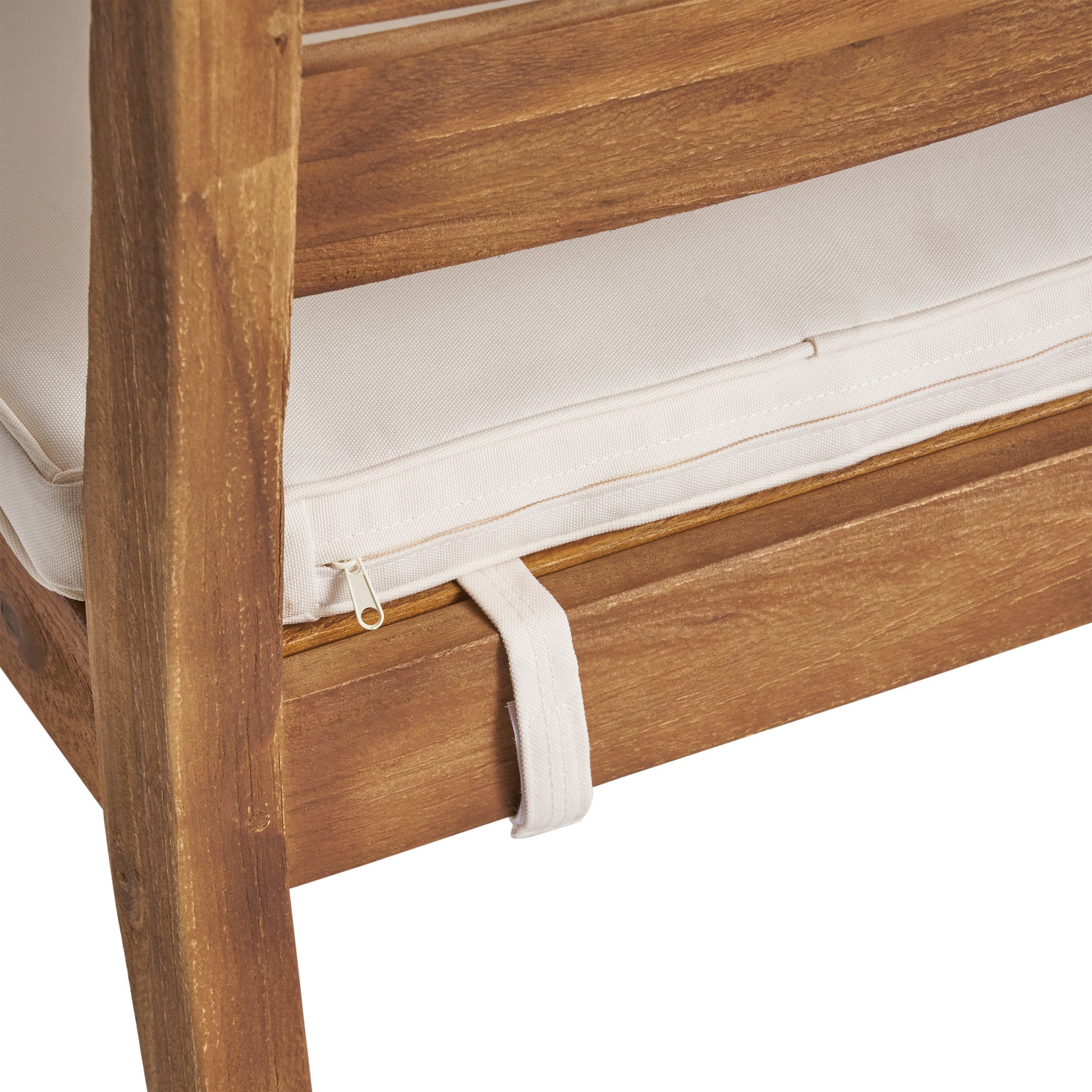 Closeup of wooden outdoor chair frame with cream cushion detail
