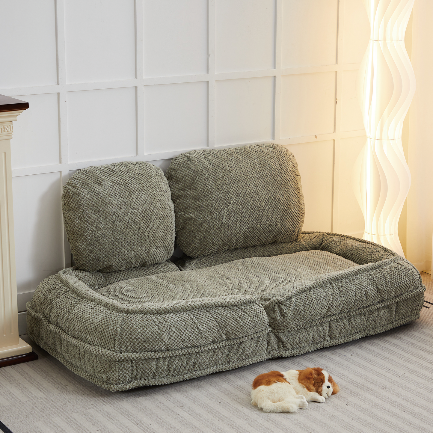 Sage green textured dog bed with plush bolsters and a central cushion