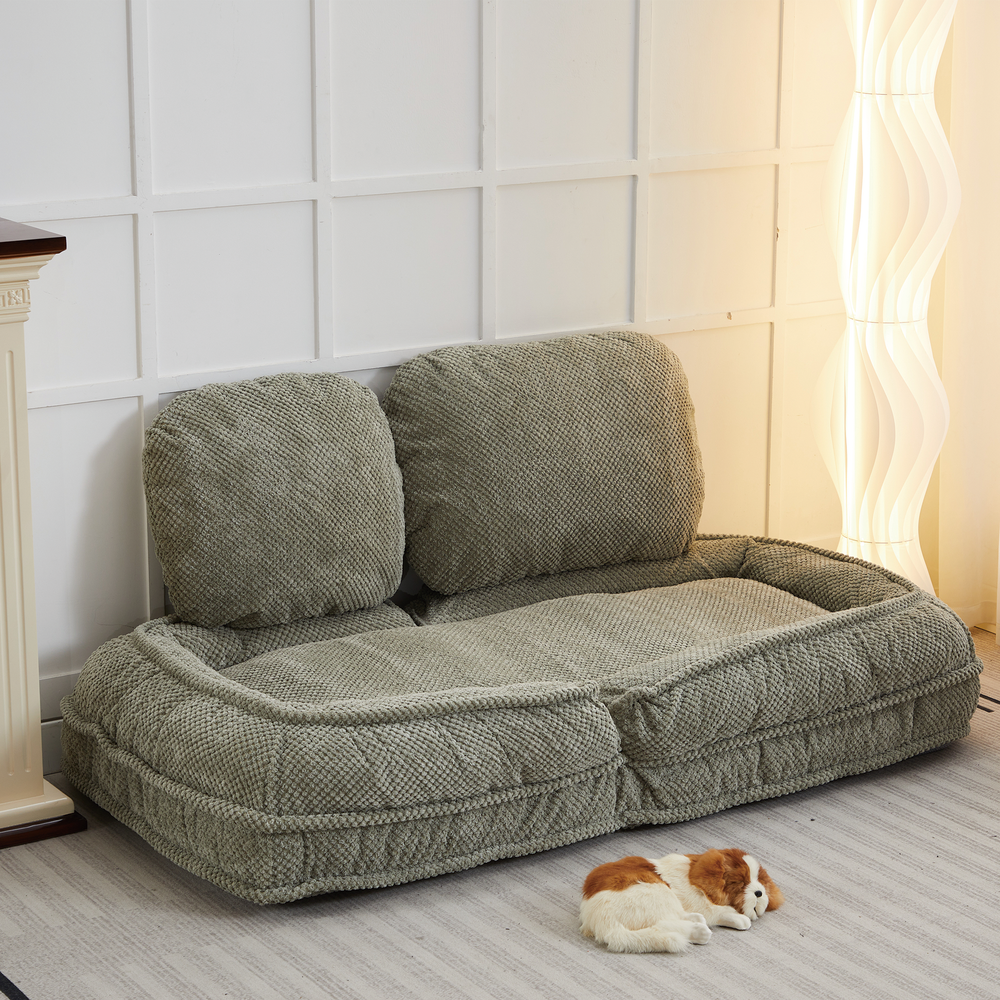 Sage green textured dog bed with plush bolsters and a central cushion