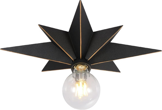 Black starburst flush mount light fixture with gold trim and exposed Edison bulb