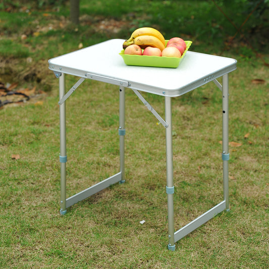 White aluminum folding picnic table with fruit on top