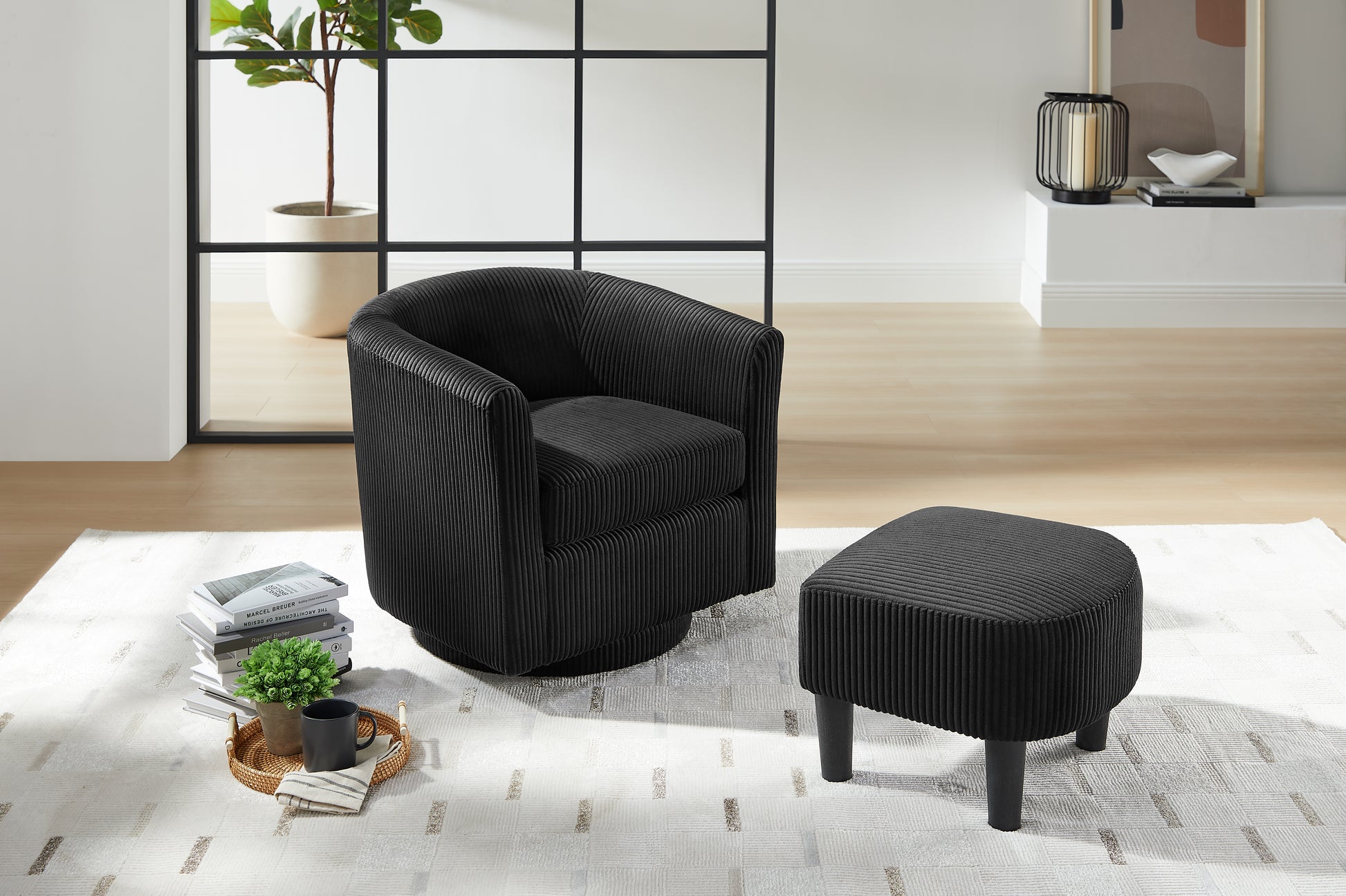 Black corduroy swivel chair with plush seating and round base