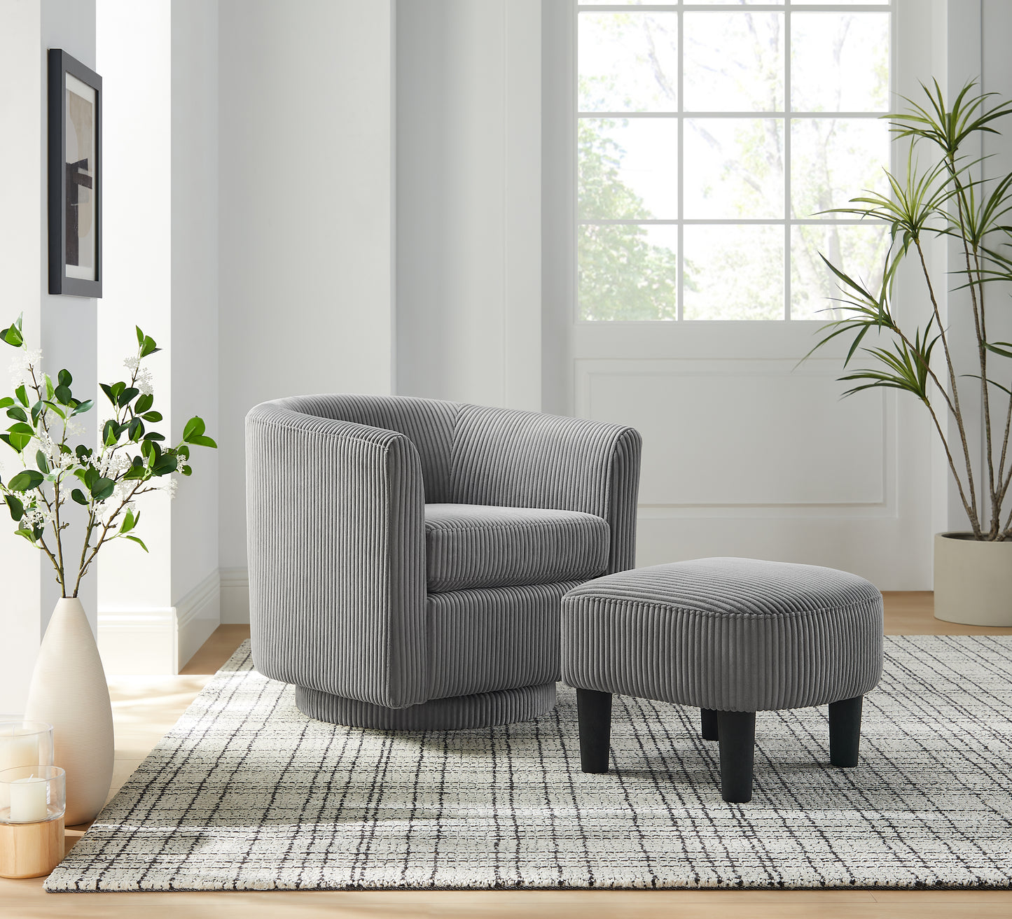 Grey swivel accent chair with corduroy upholstery and matching ottoman on a modern rug