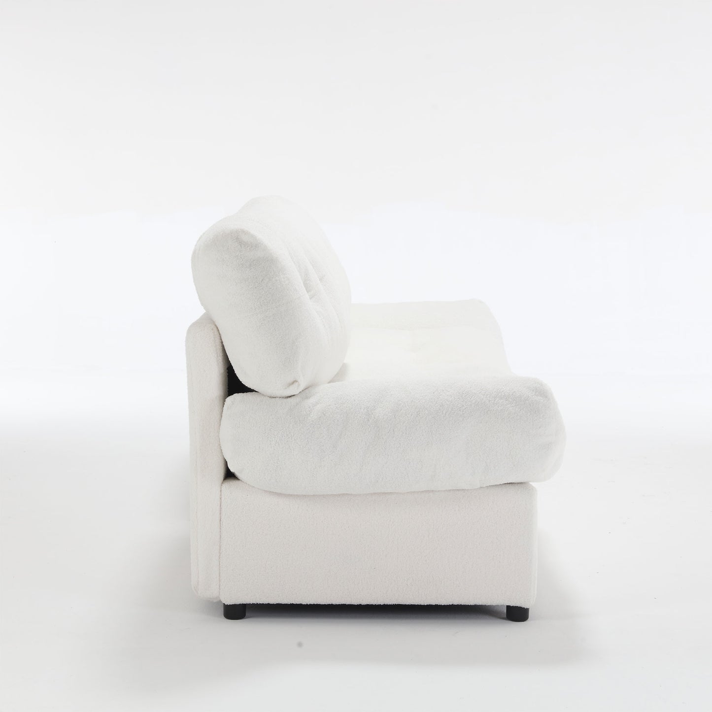 Plush white boucl armchair with deep rounded cushions and low profile for a modern living room