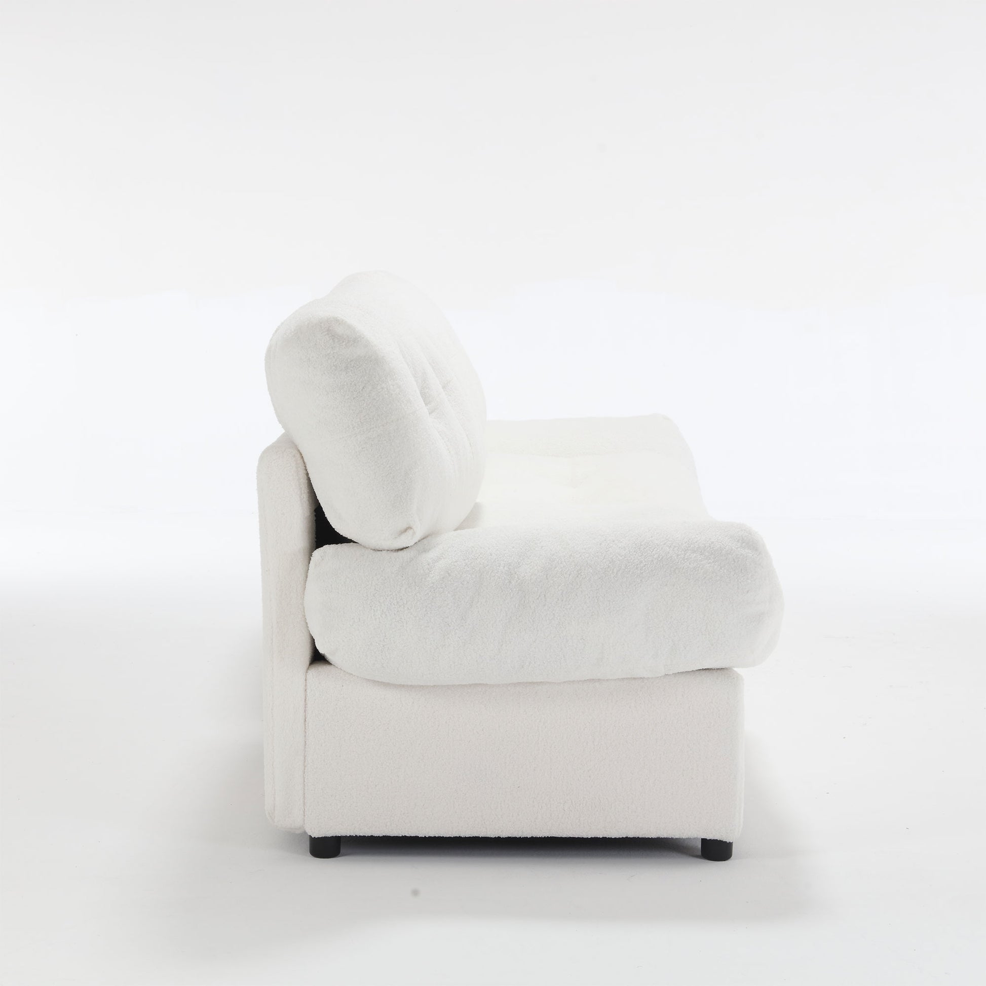 Plush white boucl armchair with deep rounded cushions and low profile for a modern living room