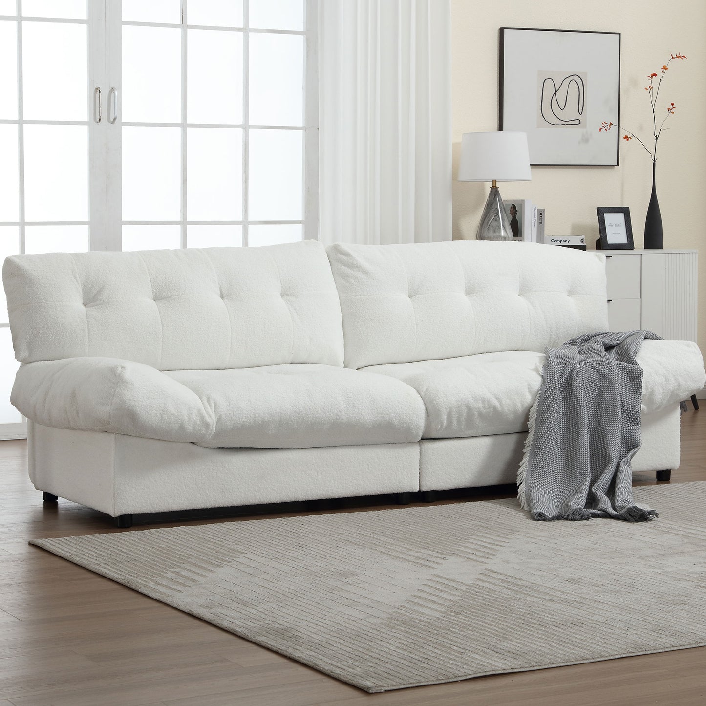 Plush white boucle sofa with deep tufting and comfortable seating for a modern living room