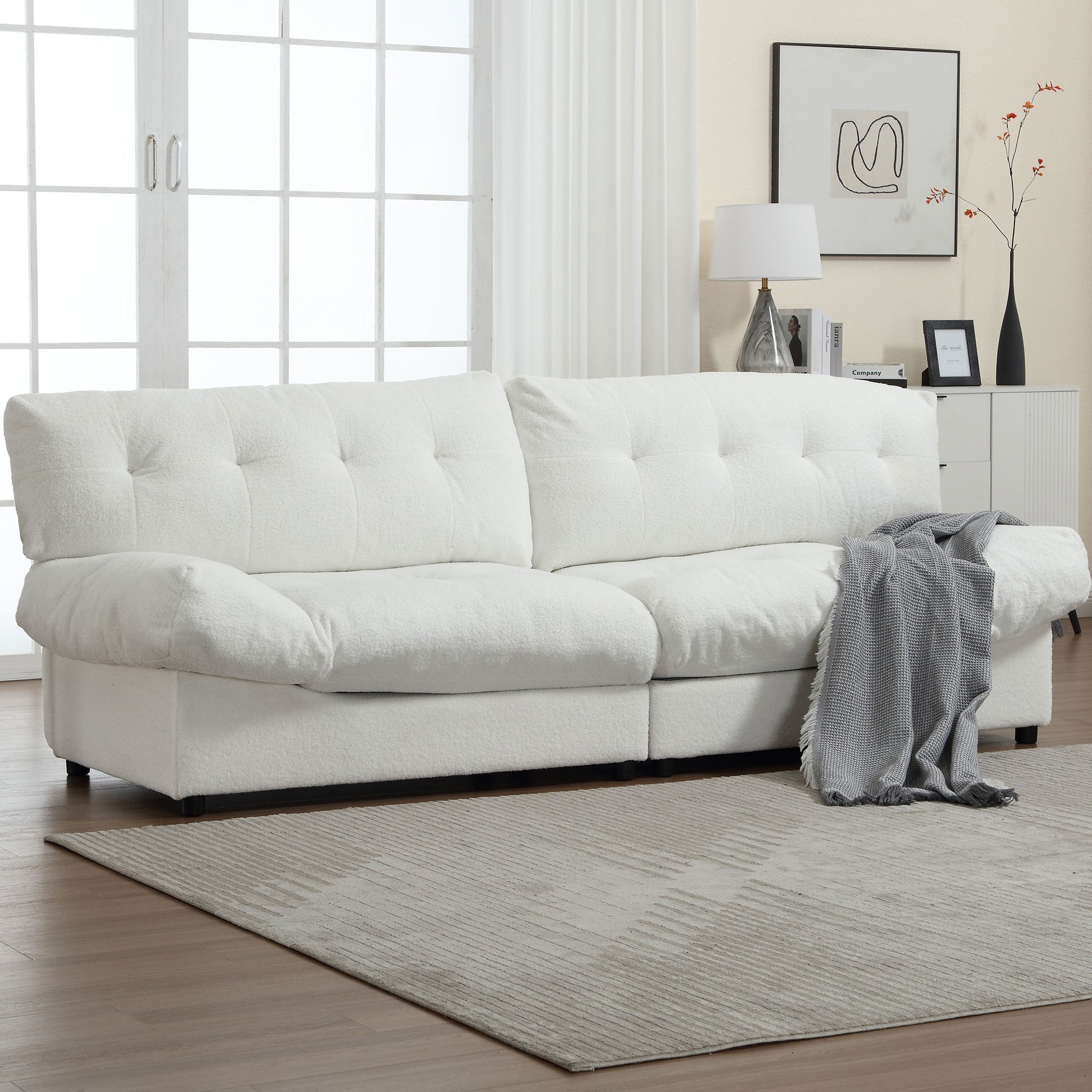 Plush white boucle sofa with deep tufting and comfortable seating for a modern living room