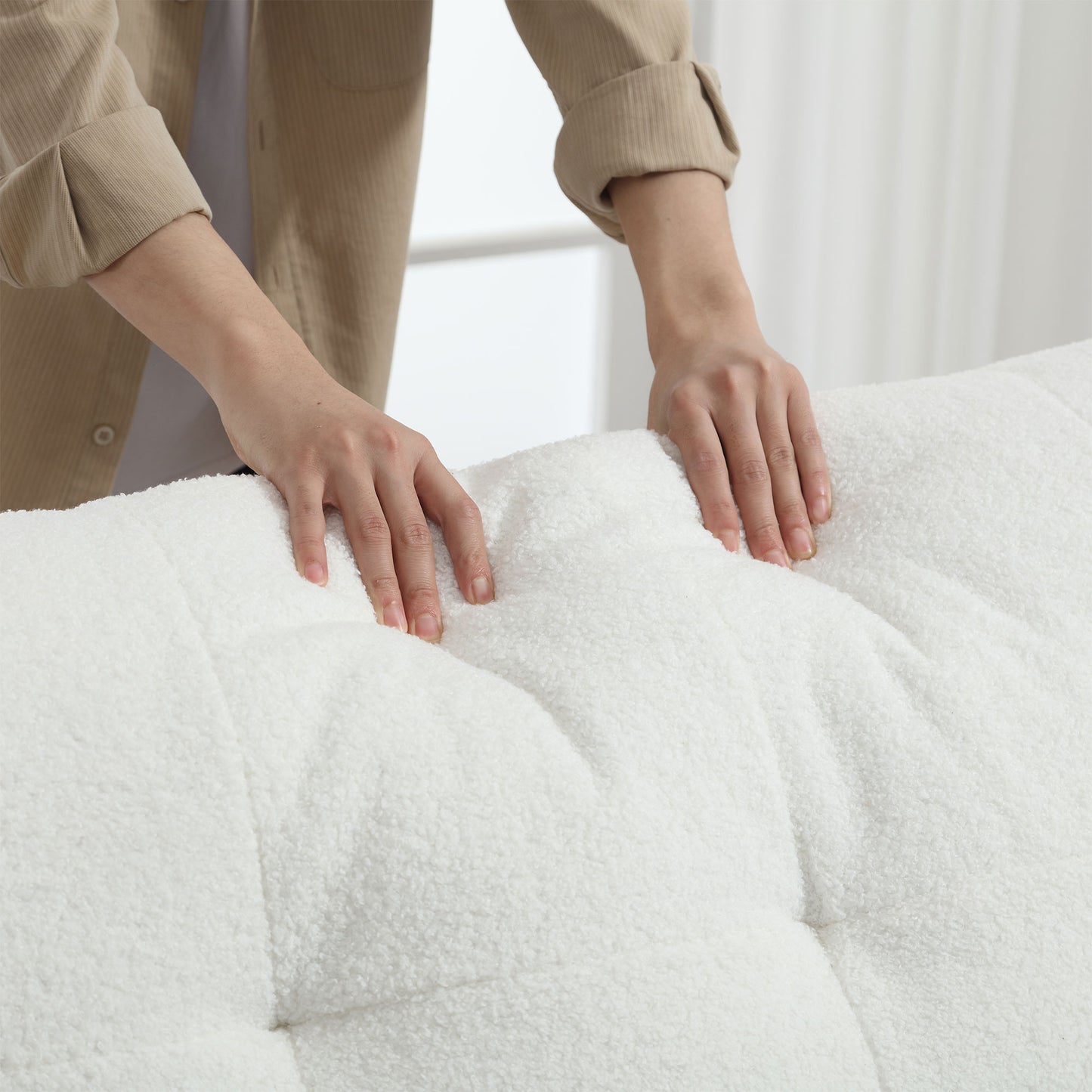 Closeup of plush white boucl fabric with tufted detailing ideal for cozy furniture