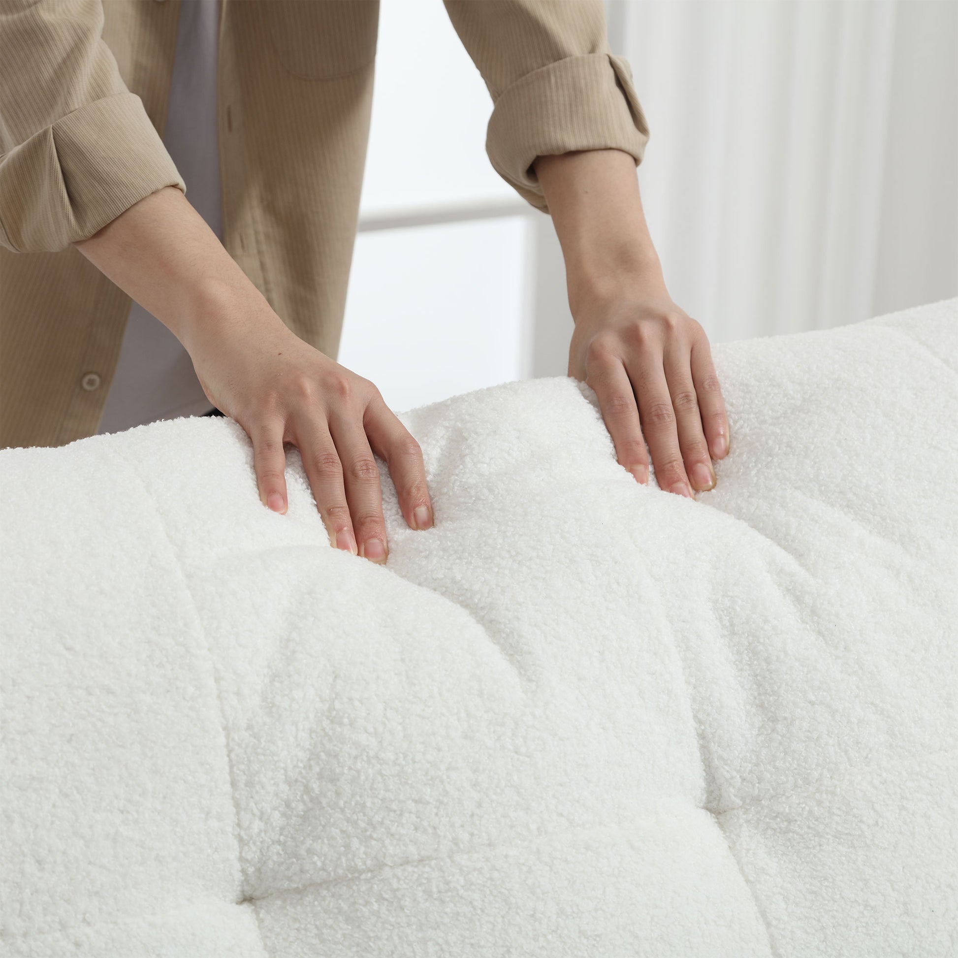 Closeup of plush white boucl fabric with tufted detailing ideal for cozy furniture