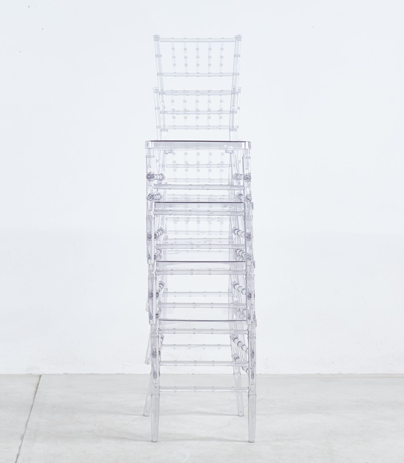 Stack of clear acrylic ghost chairs contemporary design perfect for events