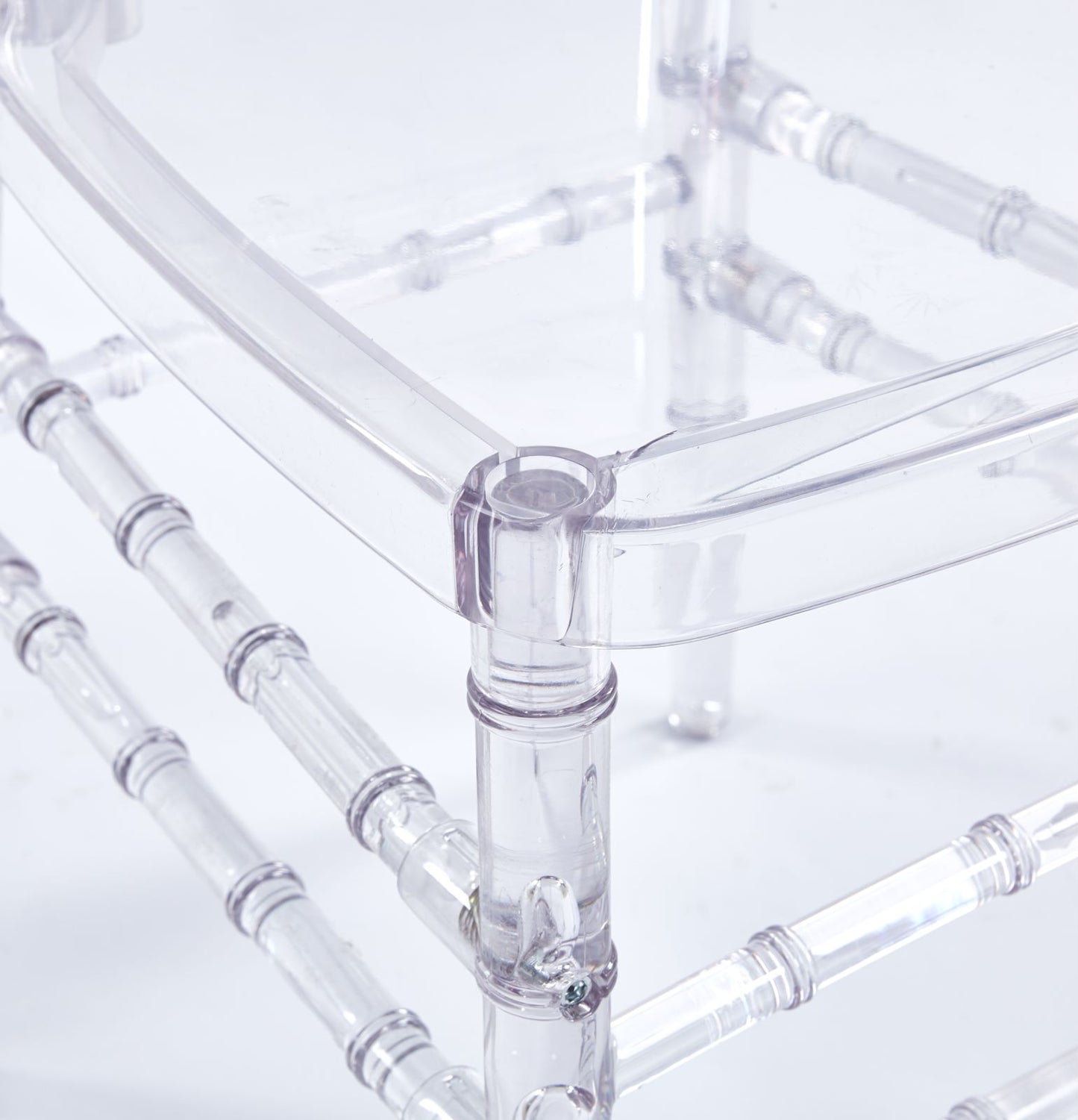Clear acrylic chair legs with bamboolike detailing for a modern look