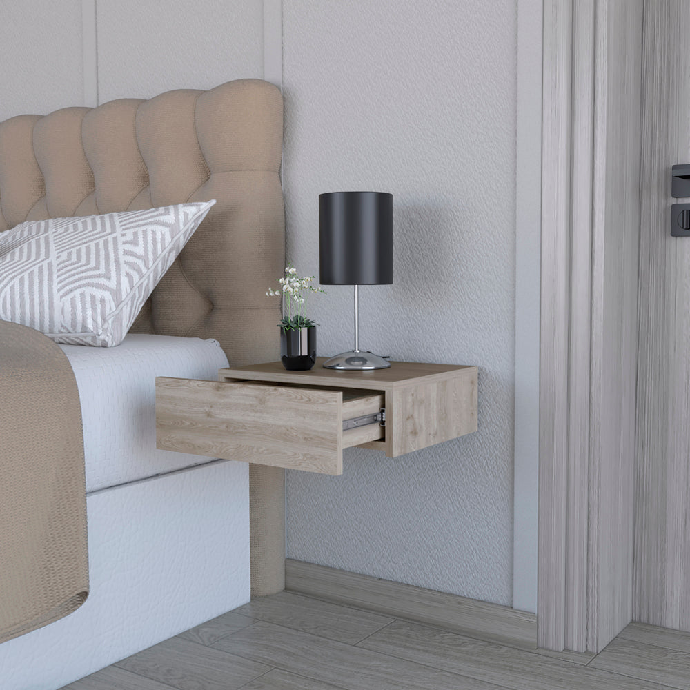 Floating nightstand with light wood grain and open drawer next to a bed