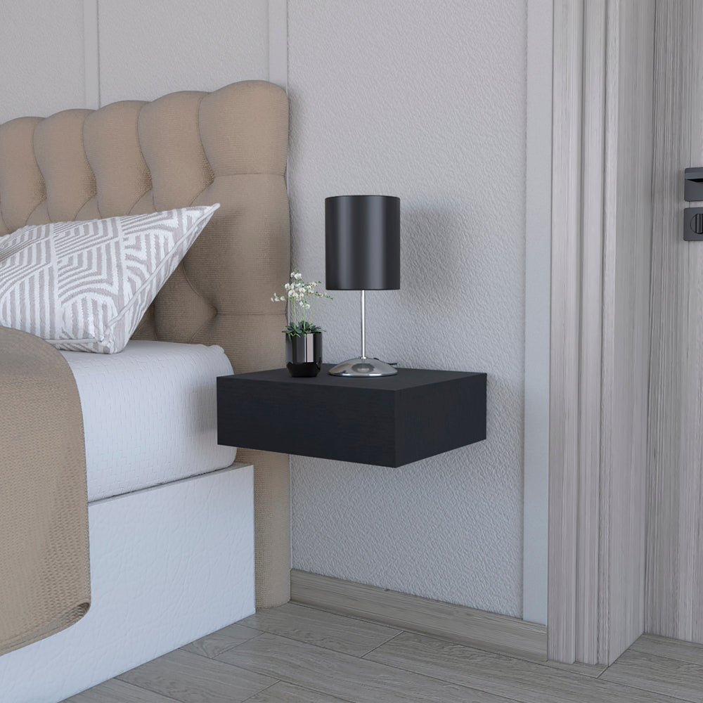 Black floating nightstand with modern design beside a tufted headboard
