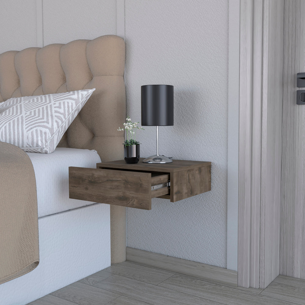 Floating nightstand with open drawer in dark wood finish beside tufted headboard