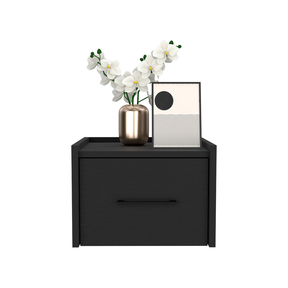 Black modern nightstand with a sleek drawer and brass vase holding white orchids