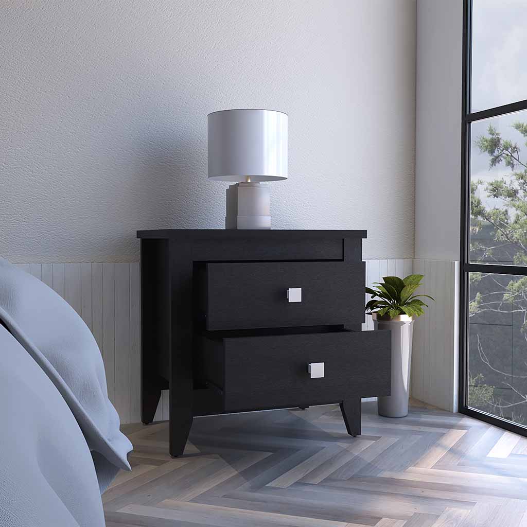Black wooden nightstand with two drawers and silver square pulls placed beside a bed