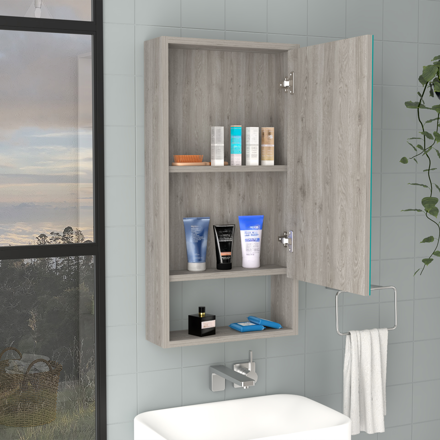Gray wood medicine cabinet with open door holding toiletries and a towel bar
