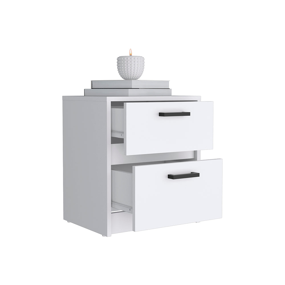 White twodrawer nightstand with black handles and stacked books with a candle on top