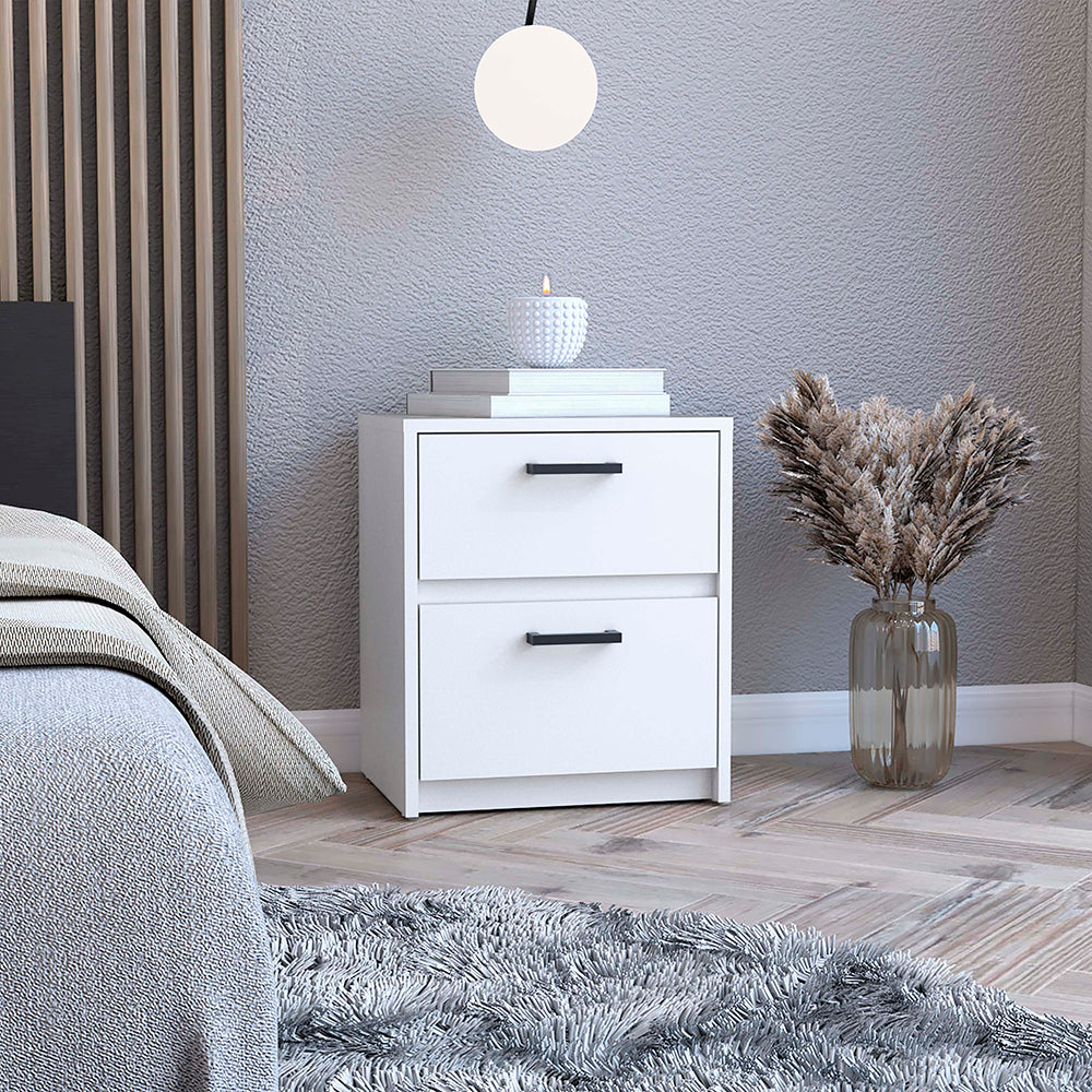 Modern white twodrawer nightstand with black hardware beside a bed