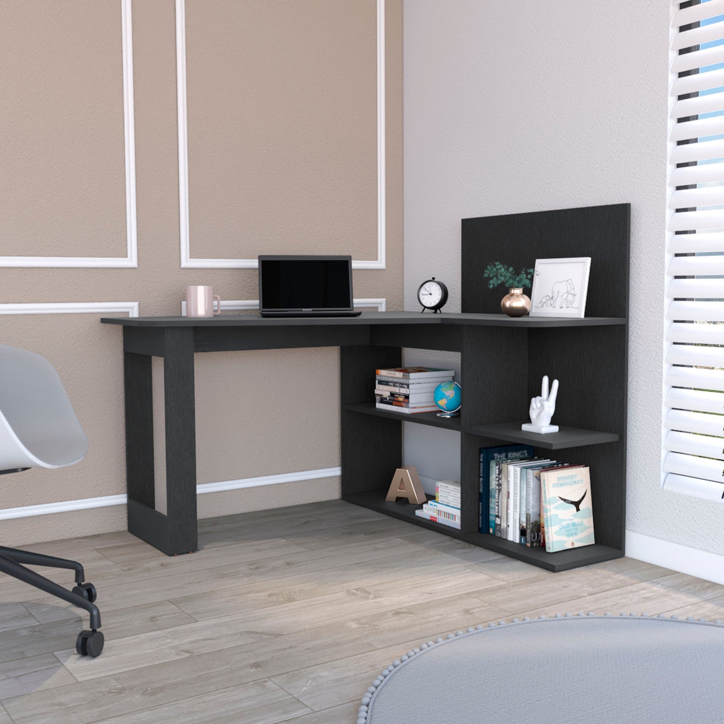 Dark gray modern corner desk with integrated shelving laptop and books