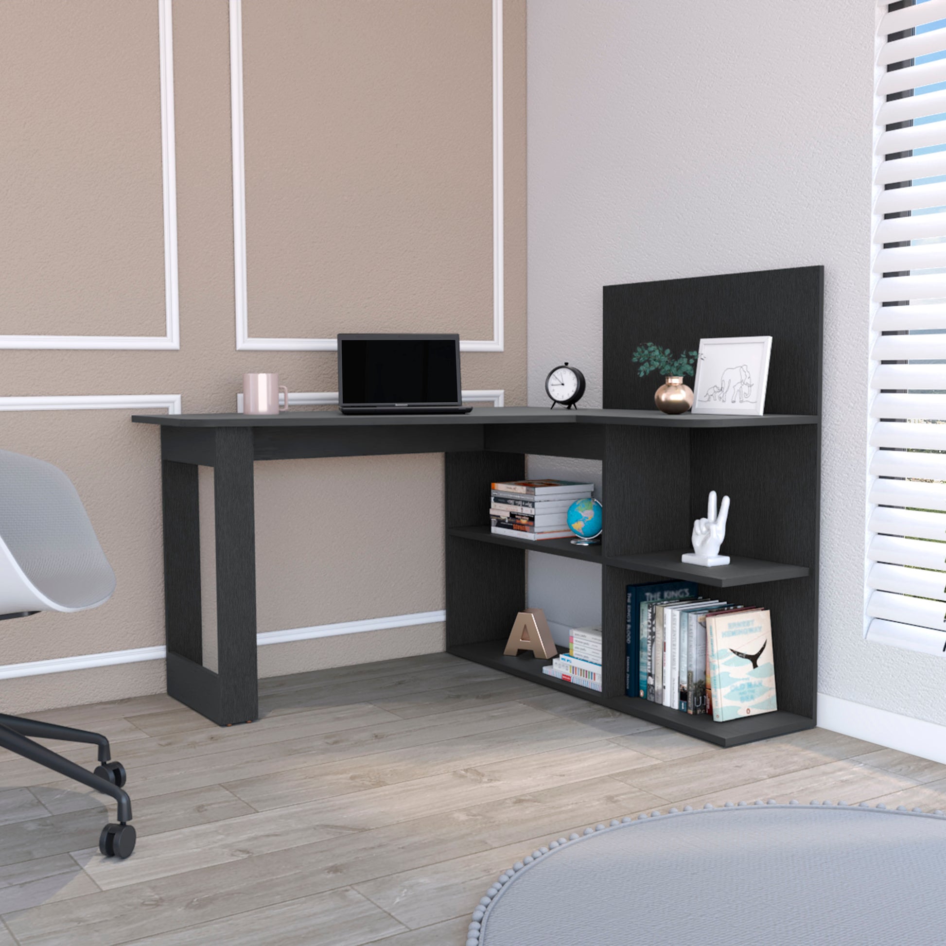 Dark gray modern corner desk with integrated shelving laptop and books