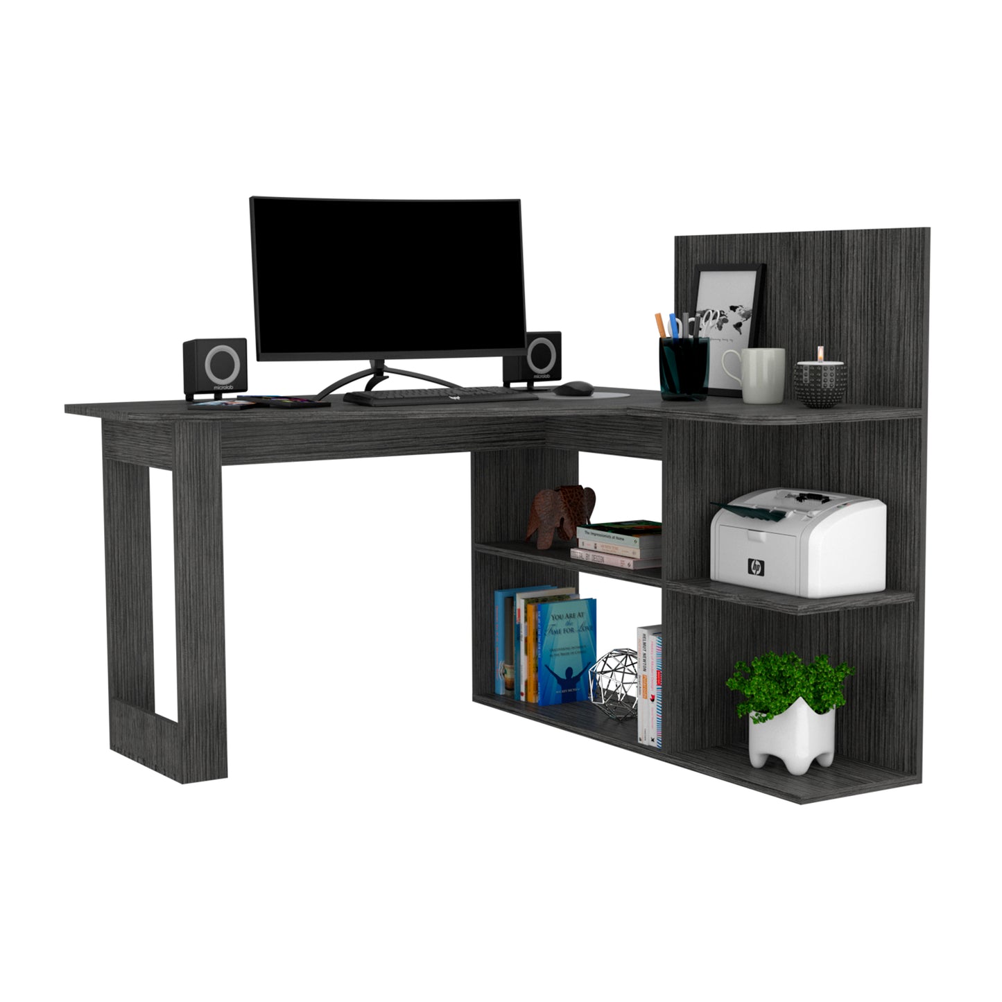 Dark grey Lshaped computer desk with builtin shelves and monitor keyboard mouse speakers and printer