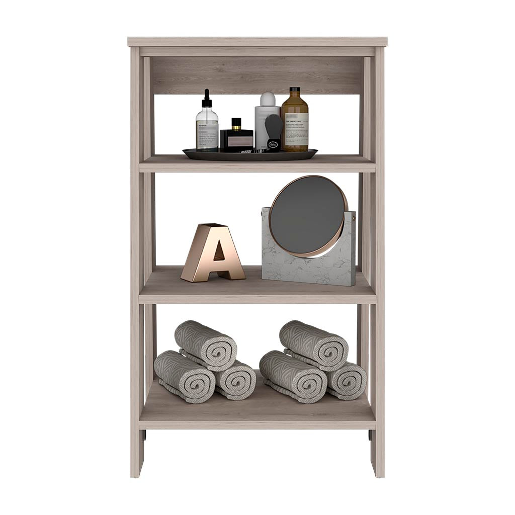 Threetier gray wood shelf unit displaying bath toiletries and rolled towels