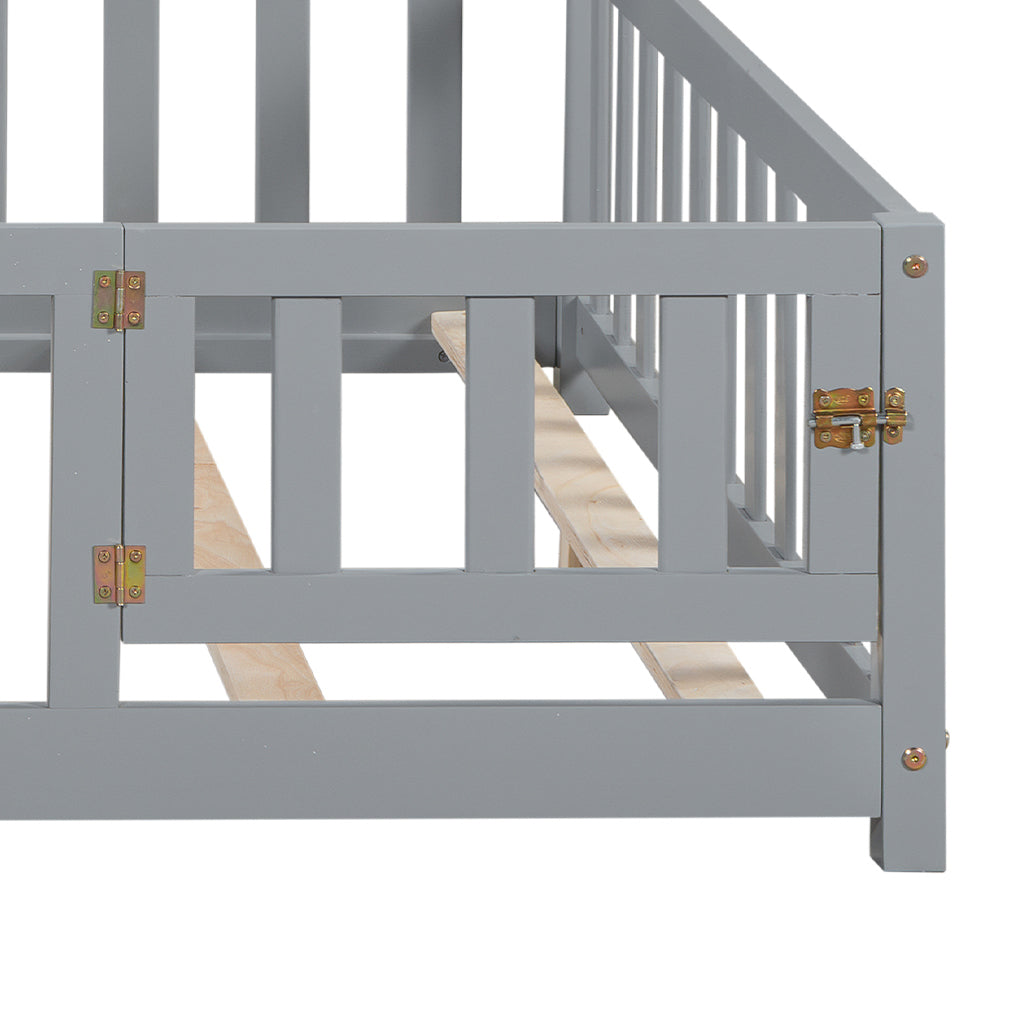 Gray wooden crib railing with brass latch detail