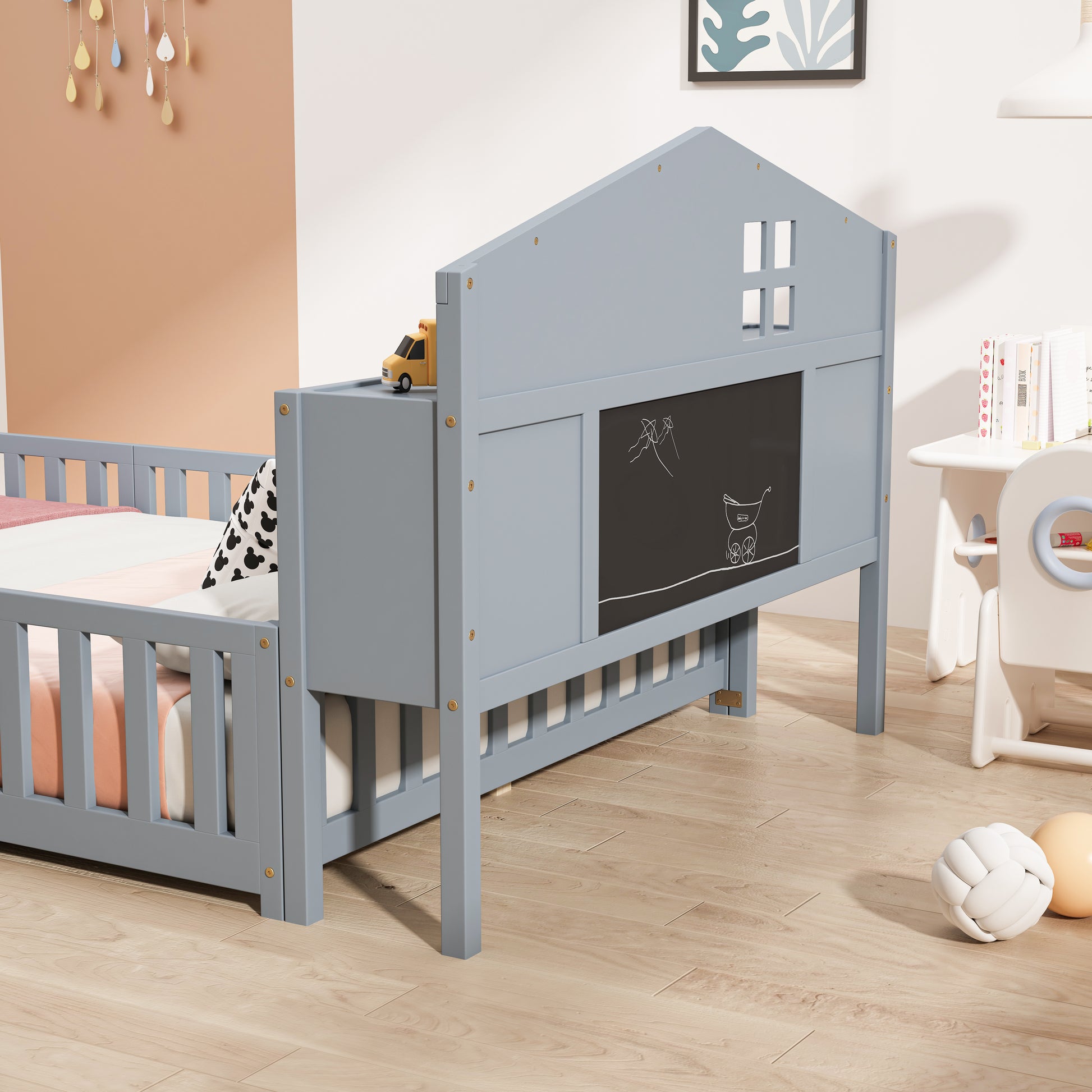 Gray wooden toddler bed with chalkboard and windows