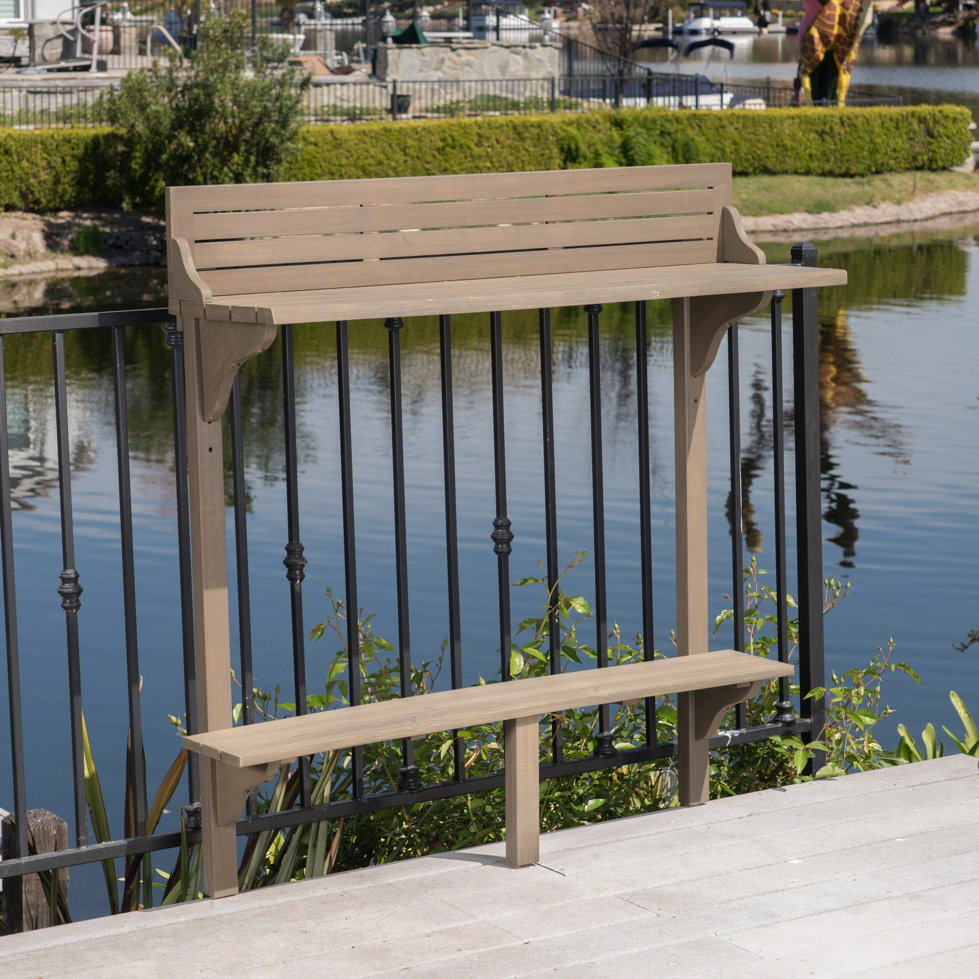 Tan composite railing bar with attached bench and shelf for outdoor entertaining